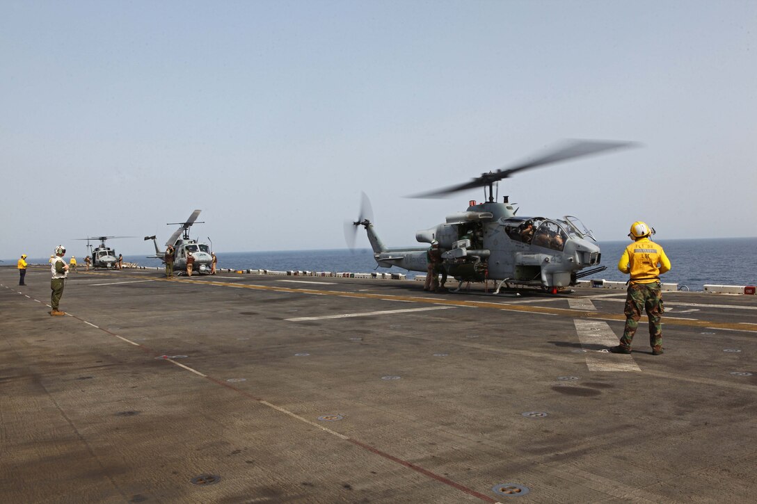 Marines with Marine Medium Tiltrotor Squadron 261 (Reinforced), 24th Marine Expeditionary Unit, conduct  maintenance ground turns on AH-1W Super Cobras and UH-1N Hueys aboard the USS Iwo Jima, Aug 27, 2012, to ensure the helicopters' components are working properly prior to conducting flight operations. The Cobras are part of the "Skid" detachment for VMM-261 (Rein) originally assigned to Marine Light Attack Helicopter Squadron 269 based at Marine Corps Air Station New River, N.C.  The 24th MEU is deployed with the Iwo Jima Amphibious Ready Group as a theater reserve force for U.S. Central Command and is providing support for maritime security operations and theater security cooperation efforts in the U.S. Navy's 5th Fleet area of responsibility.