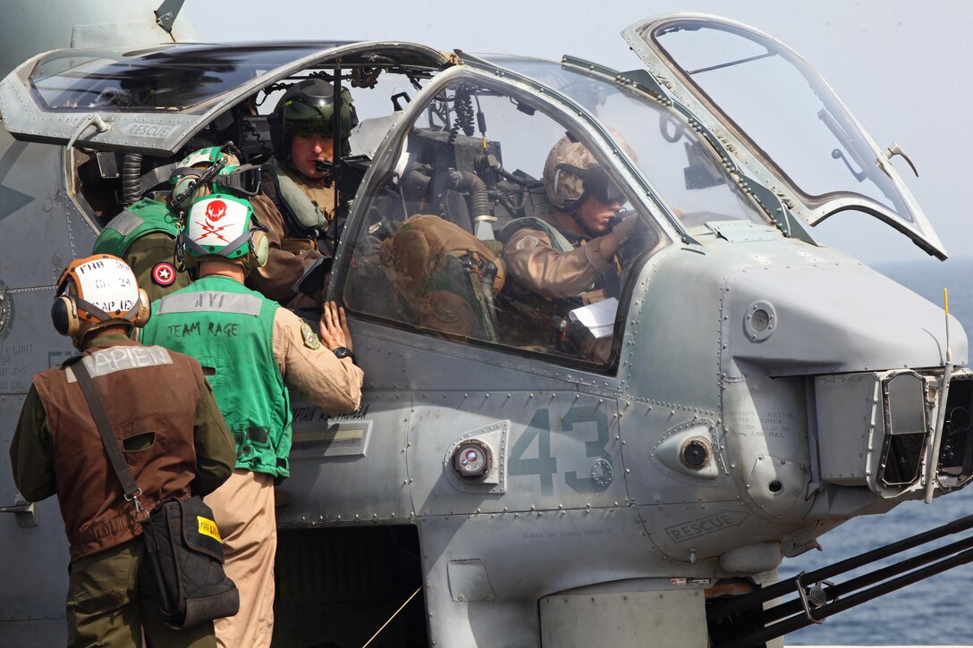 Marines with Marine Medium Tiltrotor Squadron 261 (Reinforced), 24th Marine Expeditionary Unit, conduct  maintenance ground turns with an AH-1W Super Cobra aboard the USS Iwo Jima, Aug 27, 2012, to ensure the helicopter's components are working properly prior to conducting flight operations. The Cobras are part of the "Skid" detachment for VMM-261 (Rein) originally assigned to Marine Light Attack Helicopter Squadron 269 based at Marine Corps Air Station New River, N.C.  The 24th MEU is deployed with the Iwo Jima Amphibious Ready Group as a theater reserve force for U.S. Central Command and is providing support for maritime security operations and theater security cooperation efforts in the U.S. Navy's 5th Fleet area of responsibility.