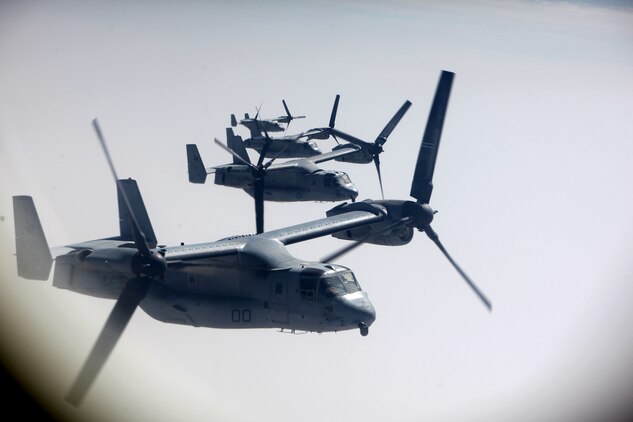 Four MV-22 Ospreys with Marine Medium Tiltrotor Squadron 261 follow a KC-130J with Detachment A, Marine Aerial Refueler Transport Squadron 352, from Helmand province, Afghanistan, to the USS Iwo Jima in the Arabian Sea, Sept. 6, 2012. The KC-130J provided an escort for the Ospreys to the ship as a contingency.