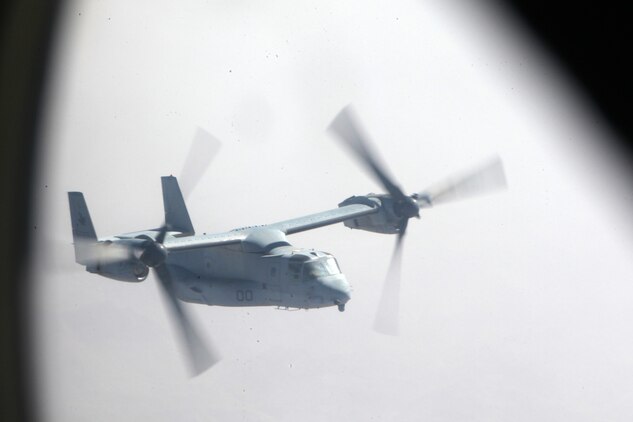 An MV-22 Osprey with Marine Medium Tiltrotor Squadron 261 follows a KC-130J with Detachment A, Marine Aerial Refueler Transport Squadron 352, from Helmand province, Afghanistan, to the USS Iwo Jima in the Arabian Sea, Sept. 6, 2012. The KC-130J provided an escort for four Ospreys to the ship as a contingency measure.