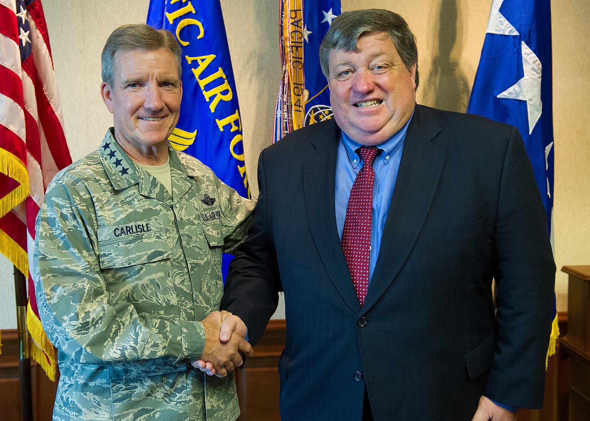 Gen. Herbert J. “Hawk” Carlisle, Pacific Air Forces commander, greets U.S. Ambassador to Nepal Peter Bodde, at the PACAF headquarters building on Joint Base Pearl Harbor-Hickam, Hawaii, Sept. 5, 2012. Bodde met briefly with Carlisle amidst Operation Pacific Angel Nepal, taking place from Sept. 10-15, 2012 in Pokhara. The U.S. military, together with host nation military personnel throughout the Asia-Pacific region, have improved the lives of tens of thousands of people through PACANGEL missions. (U.S. Air Force photo/Tech. Sgt. Jerome S. Tayborn)