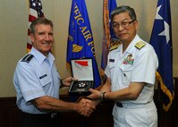 Gen. Herbert J. “Hawk” Carlisle, Pacific Air Forces commander, presents Vice Admiral Masao Kawamura, Japan Joint Staff/J3, with a souvenir gift at Headquarters PACAF, Joint Base Pearl Harbor-Hickam, Hawaii, Sept. 4, 2012. Kawamura visited PACAF to help strengthen the important relationship between the U.S. and Japan. (U.S. Air Force photo/Tech. Sgt. Jerome S. Tayborn)
