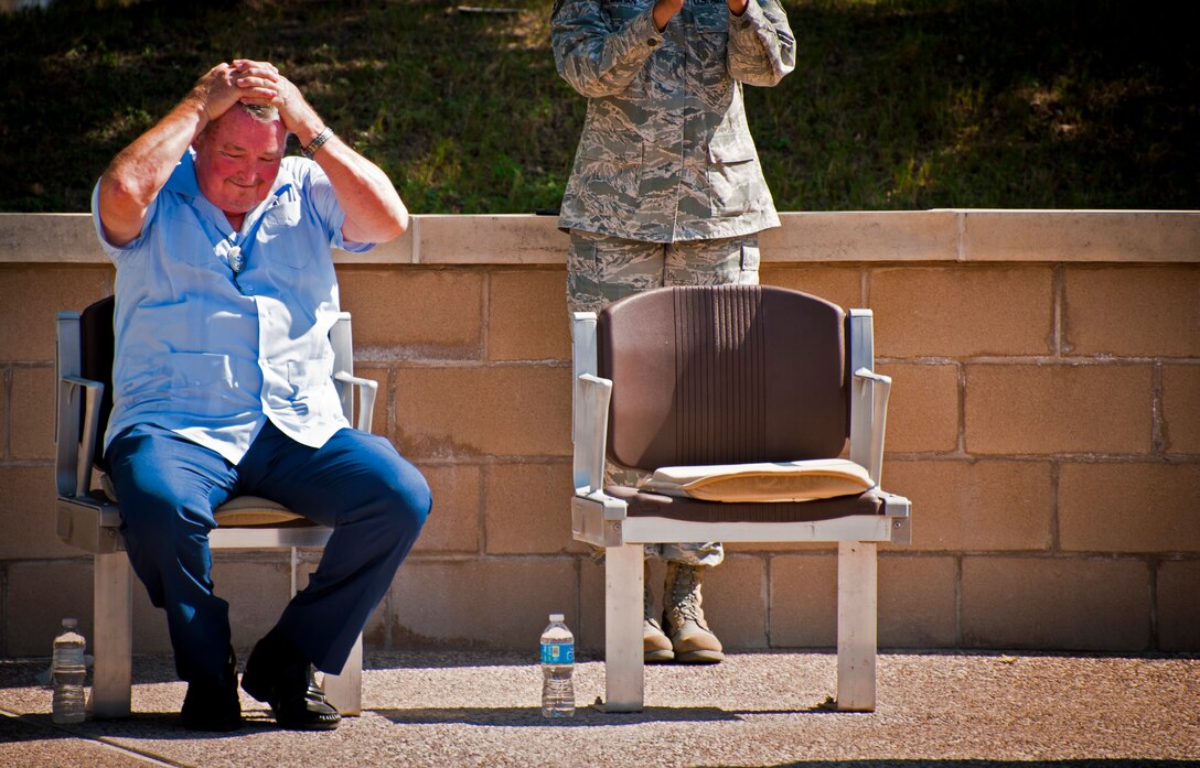 Retired Maj. Gen. Gerald Prather shows his shock after learning that the street Freedom Way was renamed to Prather Street in his honor at Laughlin Air Force Base, Texas, during a retreat ceremony held at Heritage Park here Sept. 7, 2012. Prather is one of 77 people to have a street or building named after them while still alive in the Air Force’s 64 year history. (U.S. Air Force photo/Senior Airman Scott Saldukas) 