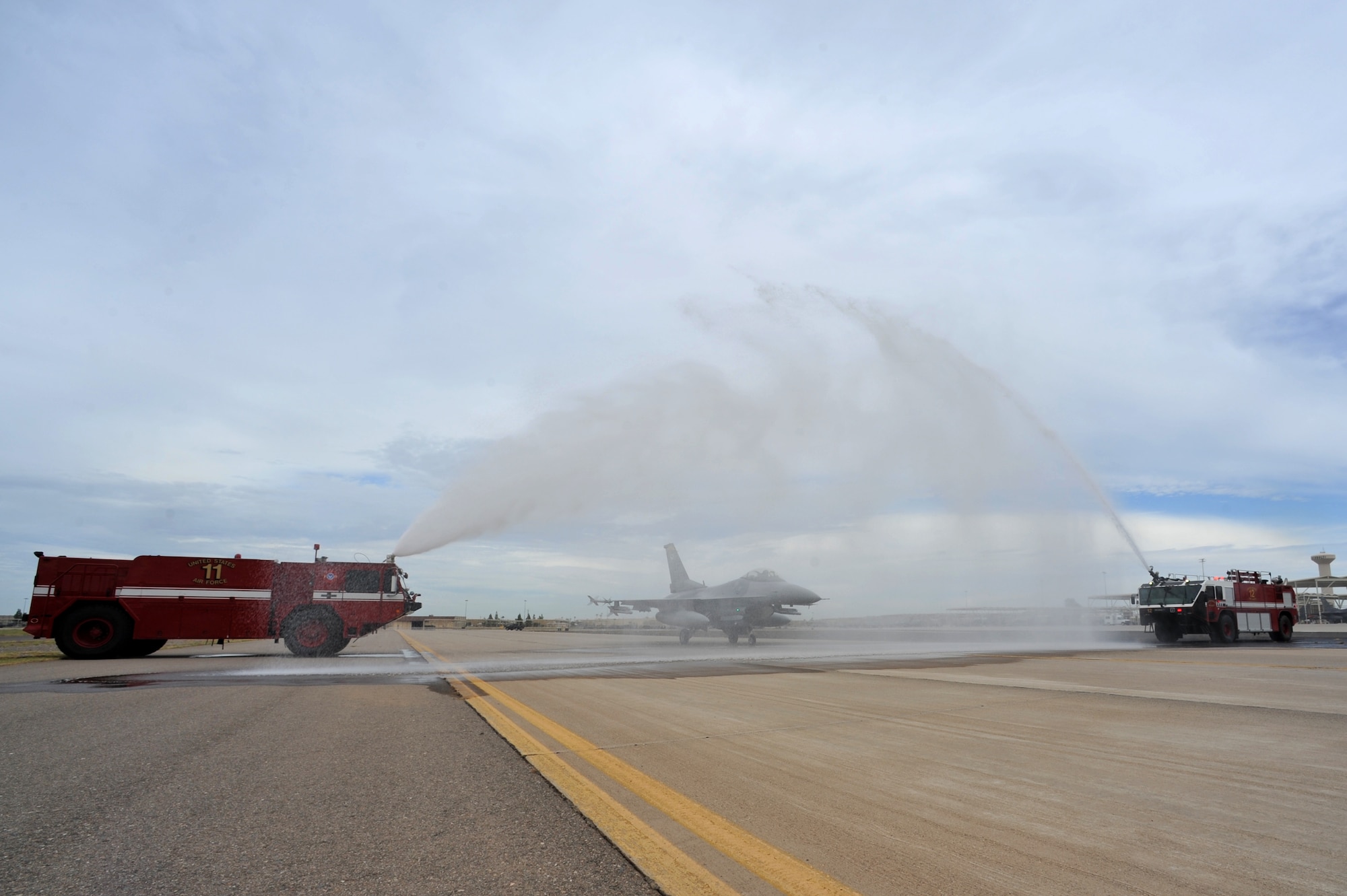The 56th Civil Engineer Squadron fire emergency services sprays down Brig. Gen. JD Harris, 56th Fighter Wing commander, upon completion of his final flight at Luke Air Force Base Sep. 7. Harris has been selected to serve as the vice commander of the 5th Air Force at Yokata Air Base, Japan.  (U.S. Air Force photo by Senior Airman Sandra Welch)