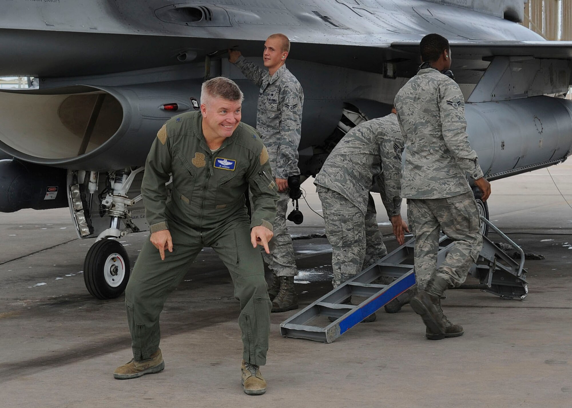 Brig. Gen. JD Harris, 56th Fighter Wing commander, braces himself before being hosed down by his wife, Heather, after his final flight at Luke Air Force Base Sep. 7. (U.S. Air Force photo by Staff Sgt. Darlene Seltmann)