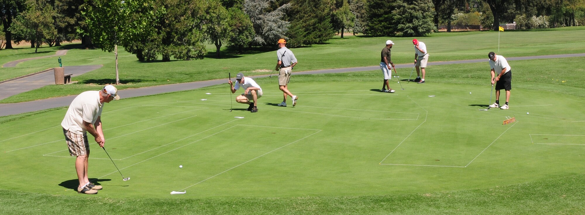 Competitors of the Beale Liaison Group Golf Tournament compete in a putting challenge at Peach Tree Golf Club Marysville, Calif., September 7, 2012. The tournament had a $5,000 hole in one challenge and many other competitions throughout the course. All proceeds benefit Beale Airmen and their families. (U.S. Air Force photo by Senior Airman Allen Pollard)