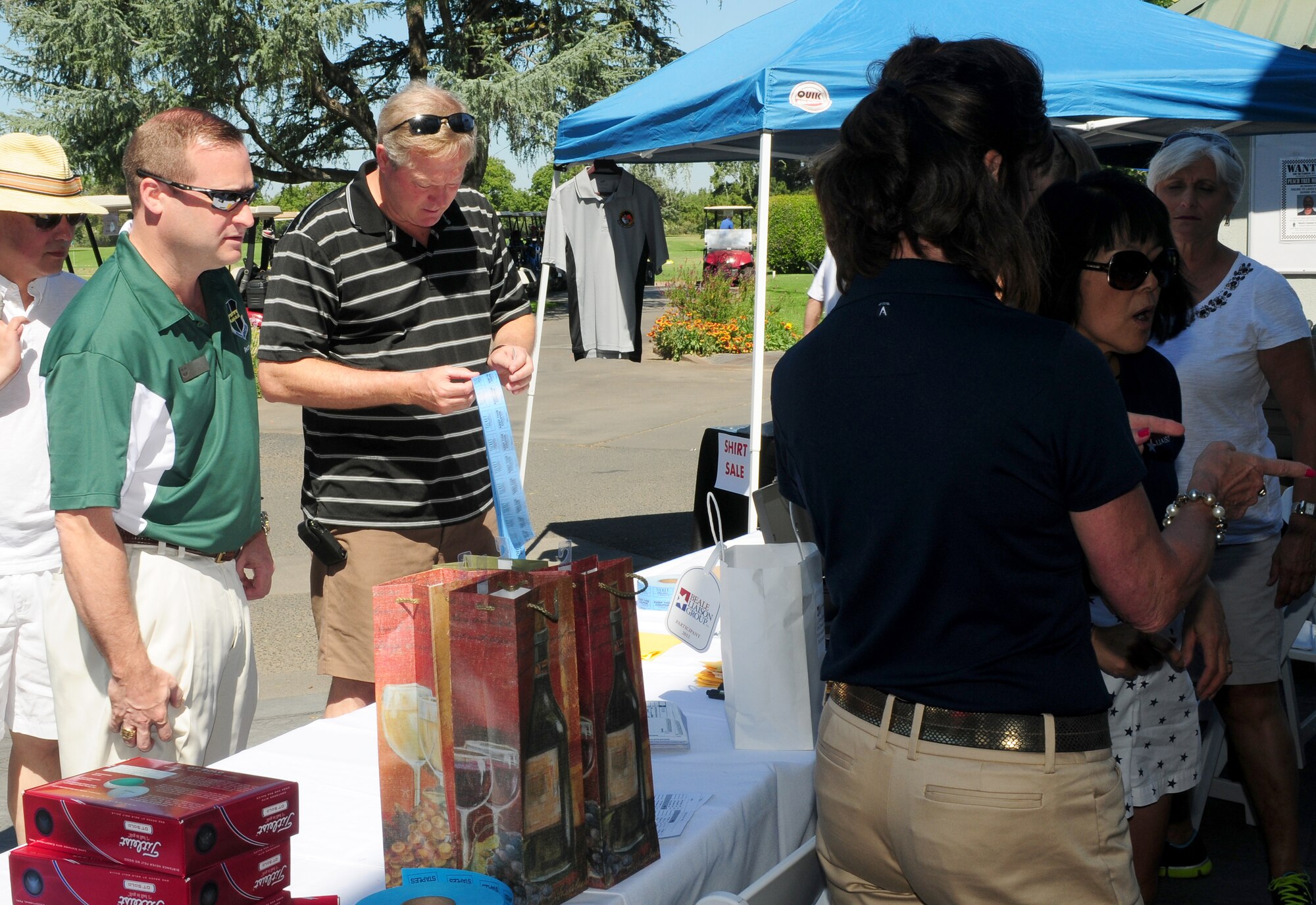 Col. Phil Stewart (left), 9th Reconnaissance Wing commander registers for the Beale Liaison Group golf tournament at Peach Tree Golf Club Marysville, Calif., September 7, 2012. BLG helps raise money for Beale Airmen and their families. (U.S. Air Force photo by Senior Airman Allen Pollard)