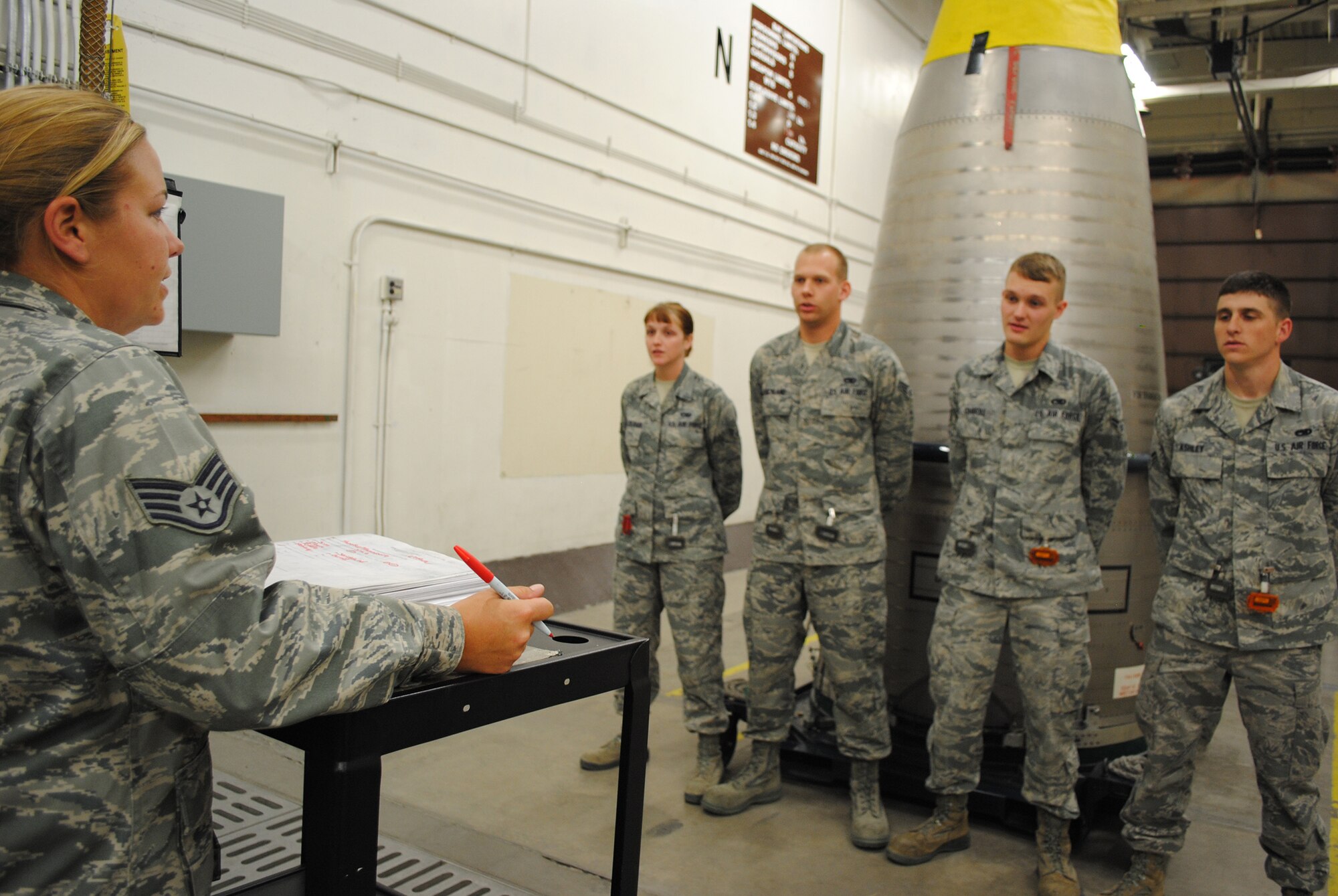 Staff Sgt. Terri Moore, 341st Munitions Squadron weapons maintenance technician and team chief in the Global Strike Challenge, runs through an extensive checklist requiring verbal acknowledgement before starting an inspection of the equipment. (U.S. Air Force photo/Airman 1st Class Katrina Heikkinen)