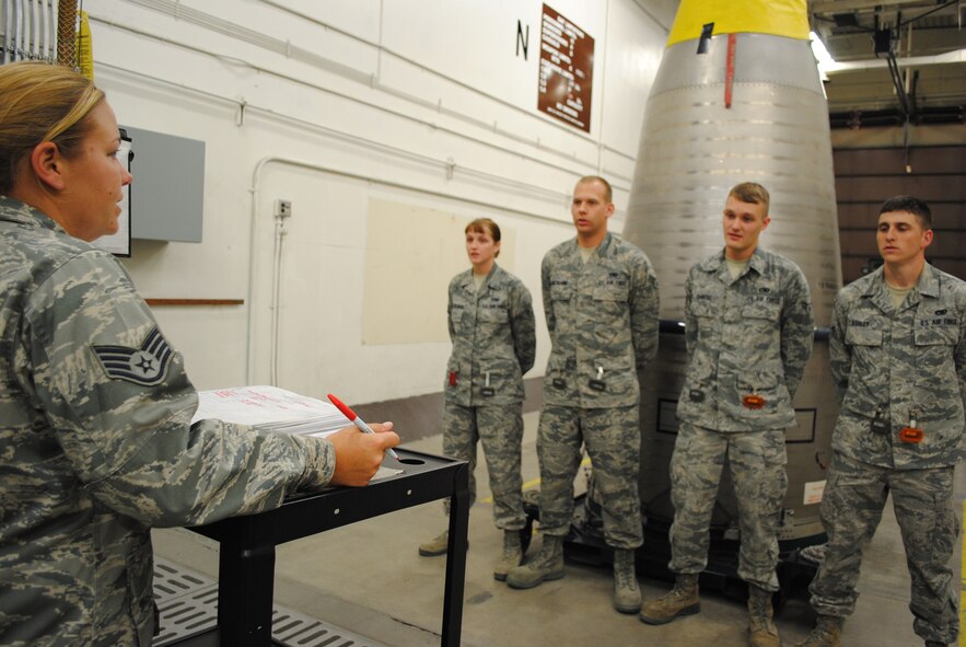 Staff Sgt. Terri Moore, 341st Munitions Squadron weapons maintenance technician and team chief in the Global Strike Challenge, runs through an extensive checklist requiring verbal acknowledgement before starting an inspection of the equipment. (U.S. Air Force photo/Airman 1st Class Katrina Heikkinen)