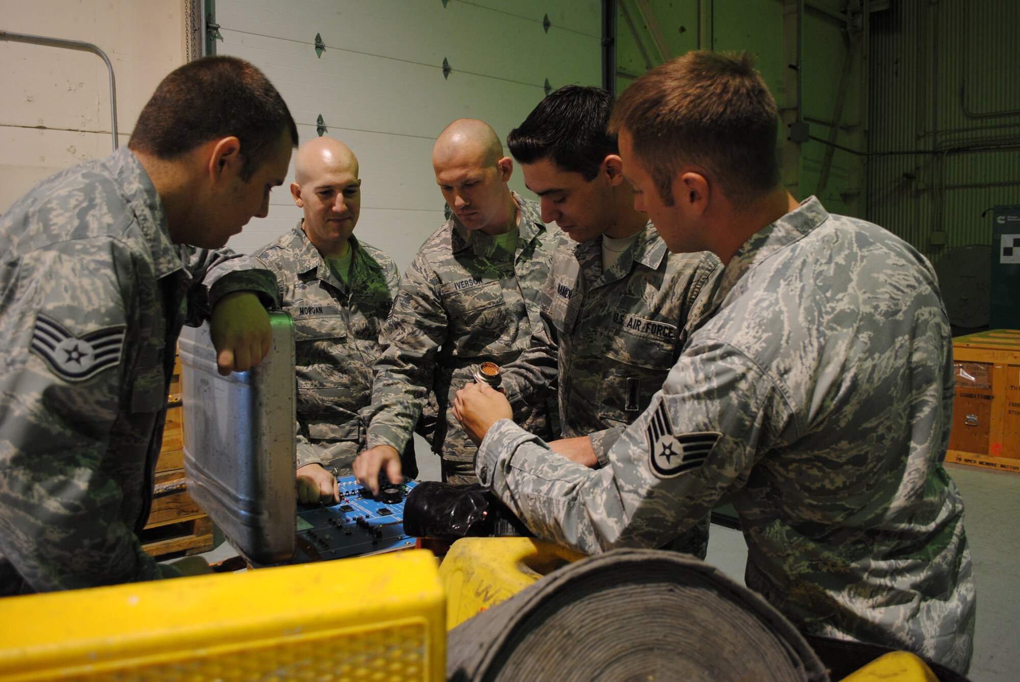 The Global Strike Challenge Facilities Maintenance Section team competitors inspect the equipment they will be using in the upcoming competition as the trainers, Staff Sgt. Christopher Petrus, 341st Maintenance Group FMS evaluator, far left, and Staff Sgt. Michael Marshall, 341st Maintenance Operations Squadron facilities maintenance team instructor, far right, look on. (U.S. Air Force photo/Airman 1st Class Katrina Heikkinen)