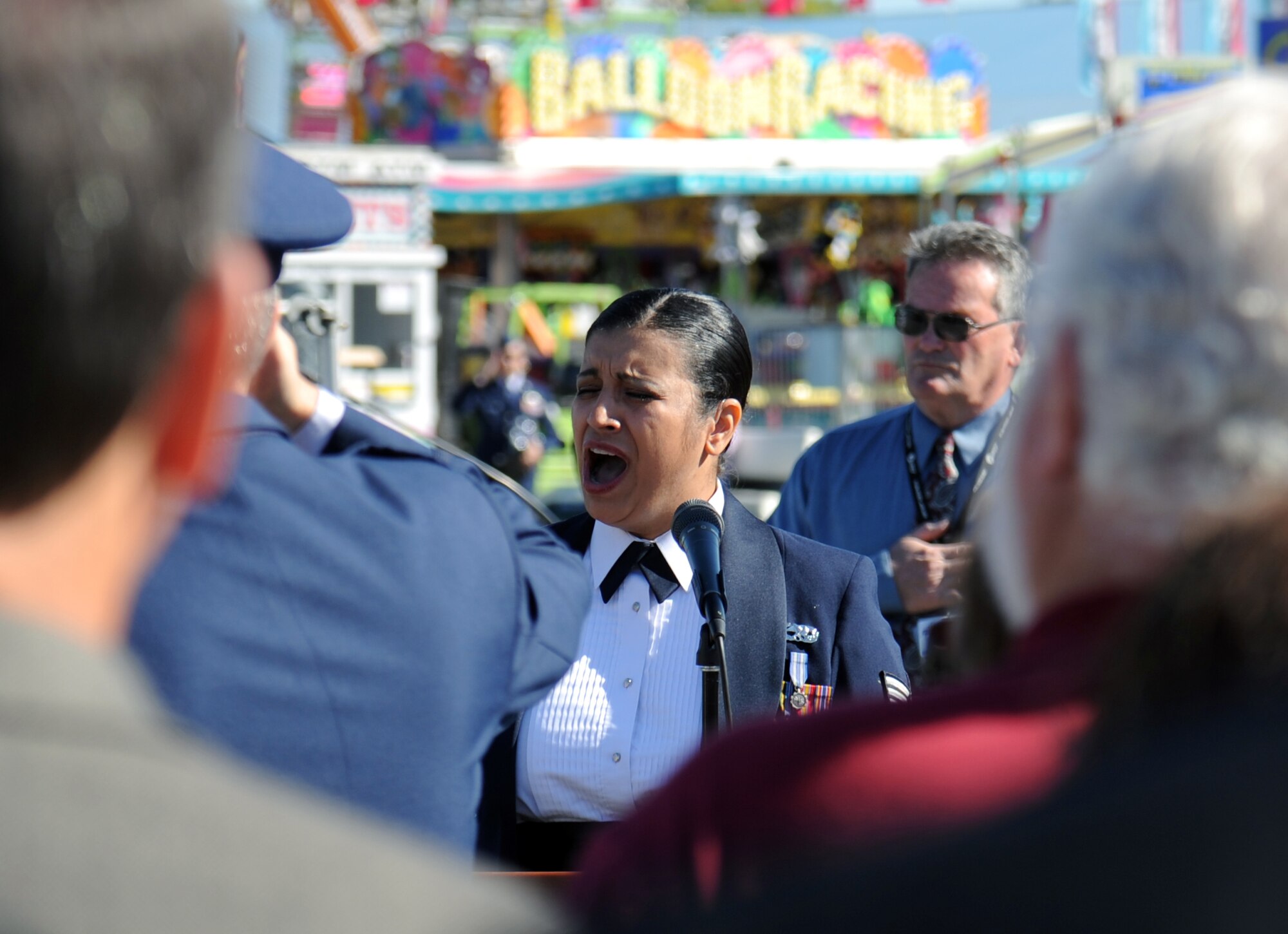 Staff Sgt. Abigail Foster, 92nd Maintenance Squadron non-destructive inspection journeyman, sings the National Anthem during the opening ceremonies for the 61st Annual Spokane County Interstate Fair in Spokane, Wash., Sept. 7, 2012. Foster is scheduled to sing at several other events during the two-week long festival. (U.S. Air Force photo by Senior Airman Benjamin Stratton)