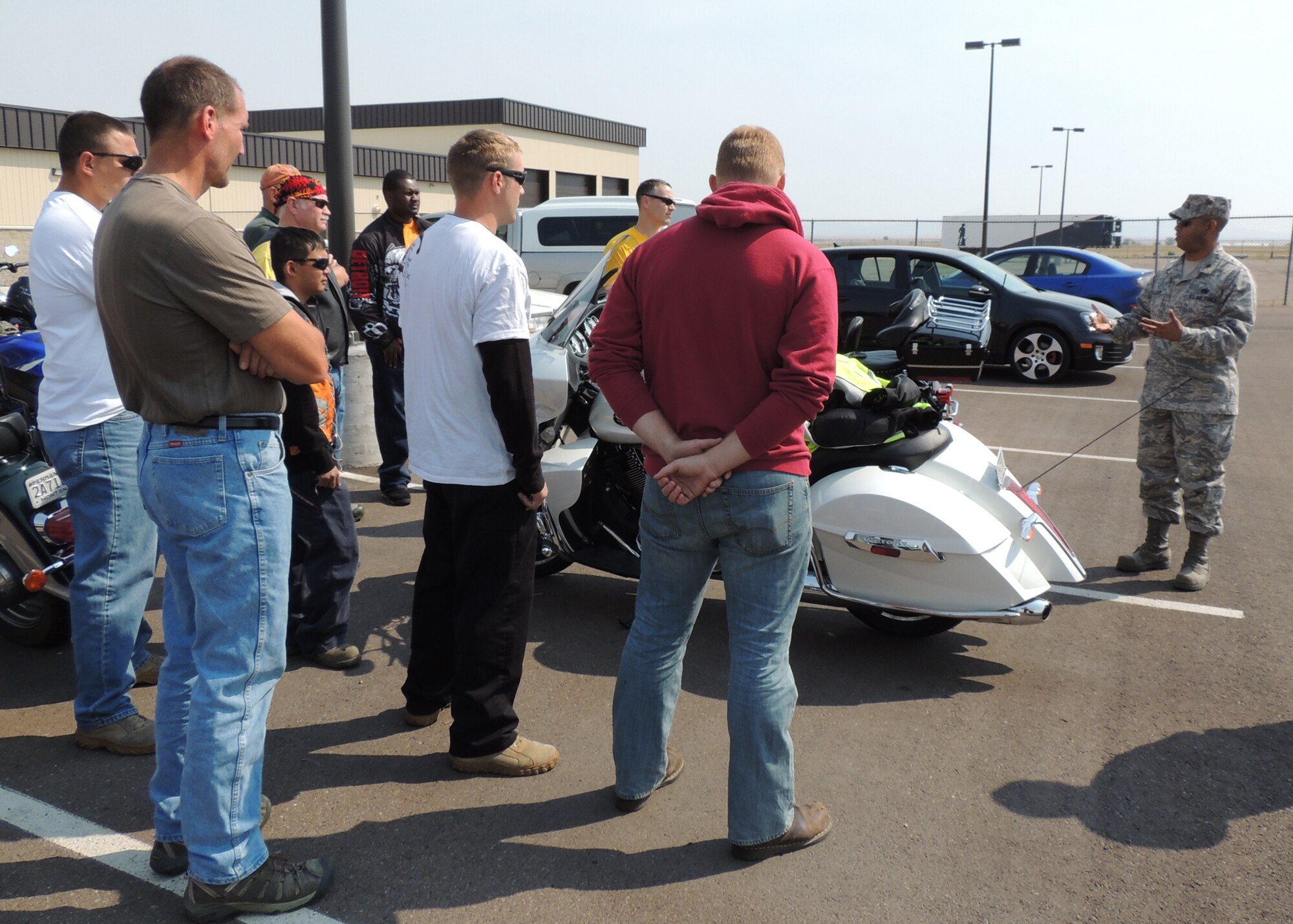 Maj. Eric Gillespie, 341st Logistics Readiness Squadron commander, far right, briefs the members participating in the mentorship ride on the importance of looking after each other.  Prior to leaving for their 127.4-mile ride, the group had personal protective equipment checks, a safety brief and a hand signals meaning brief.  (U.S. Air Force courtesy photo)