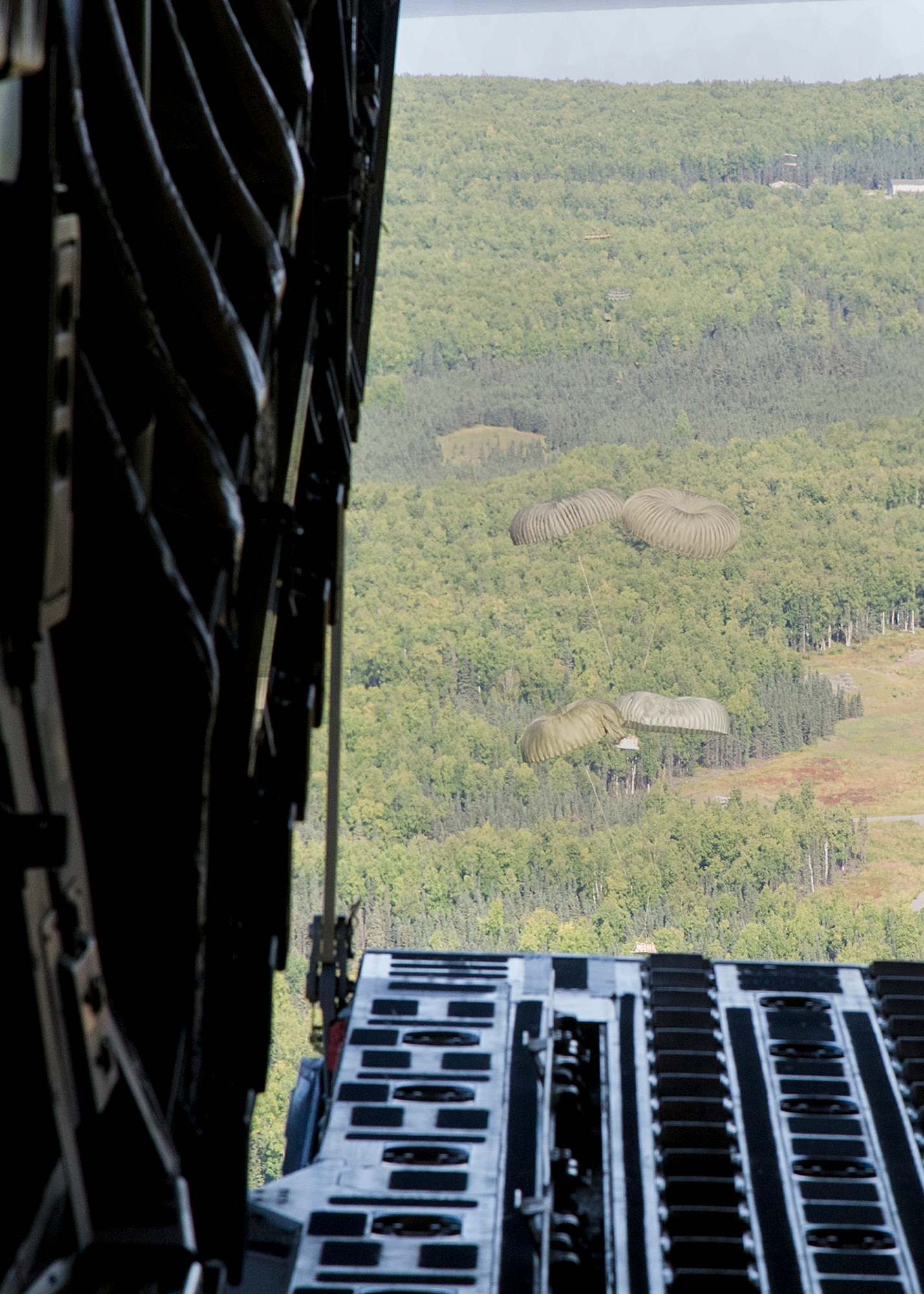 Training pallets parachute towards the drop zone from a Globemaster III cargo plane during training over Joint Base Elmendorf-Richardson, Aug. 28, 2012. C-17 aircraft from JBER support a variety of missions around the world, many of which include dropping U.S. Army paratroopers. (U.S. Air Force photo by Staff Sgt. Zachary Wolf)