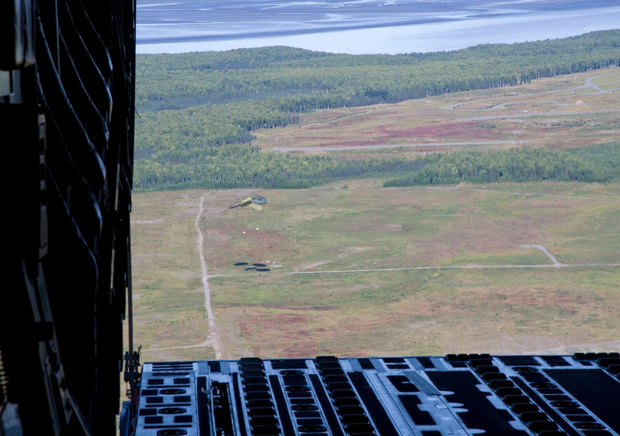 Training pallets parachute towards the drop zone from a Globemaster III cargo plane during training over Joint Base Elmendorf-Richardson, Aug. 28, 2012. C-17 aircraft from JBER support a variety of missions around the world, many of which include dropping U.S. paratroopers. (U.S. Air Force photo by Staff Sgt. Zachary Wolf)
