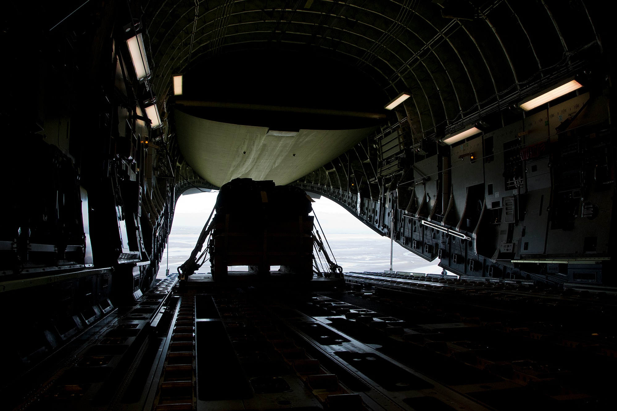 A training pallet is about to drop from a 517th Airlift Squadron C-17 Globemaster III cargo plane during training over Joint Base Elmendorf-Richardson, Aug. 28, 2012. C-17 aircraft from JBER support a variety of missions around the world, many of which include dropping U.S. Army  paratroopers. (U.S. Air Force photo by Staff Sgt. Zachary Wolf)