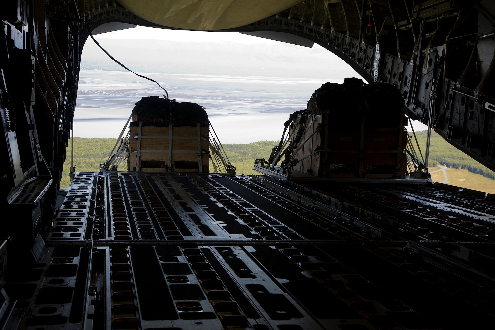 Training pallets drop from a 517th Airlift Squadron C-17 Globemaster III cargo plane during training over Joint Base Elmendorf-Richardson, Aug. 28, 2012. C-17 aircraft from JBER support a variety of missions around the world, many of which include dropping U.S. Army paratroopers. (U.S. Air Force photo by Staff Sgt. Zachary Wolf)