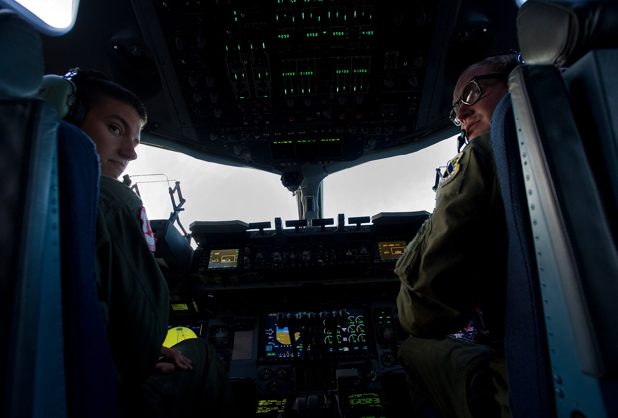 Air Force captains Allin Oberlin (left) and Zach Deshetler, 517th Airlift Squadron C-17 Globemaster III cargo plane pilots, fly their C-17 during training over Joint Base Elmendorf-Richardson, Aug. 23, 2012. C-17 aircraft from JBER support a variety of missions around the world, many of which include dropping U.S. Army paratroopers. (U.S. Air Force photo by Staff Sgt. Zachary Wolf)