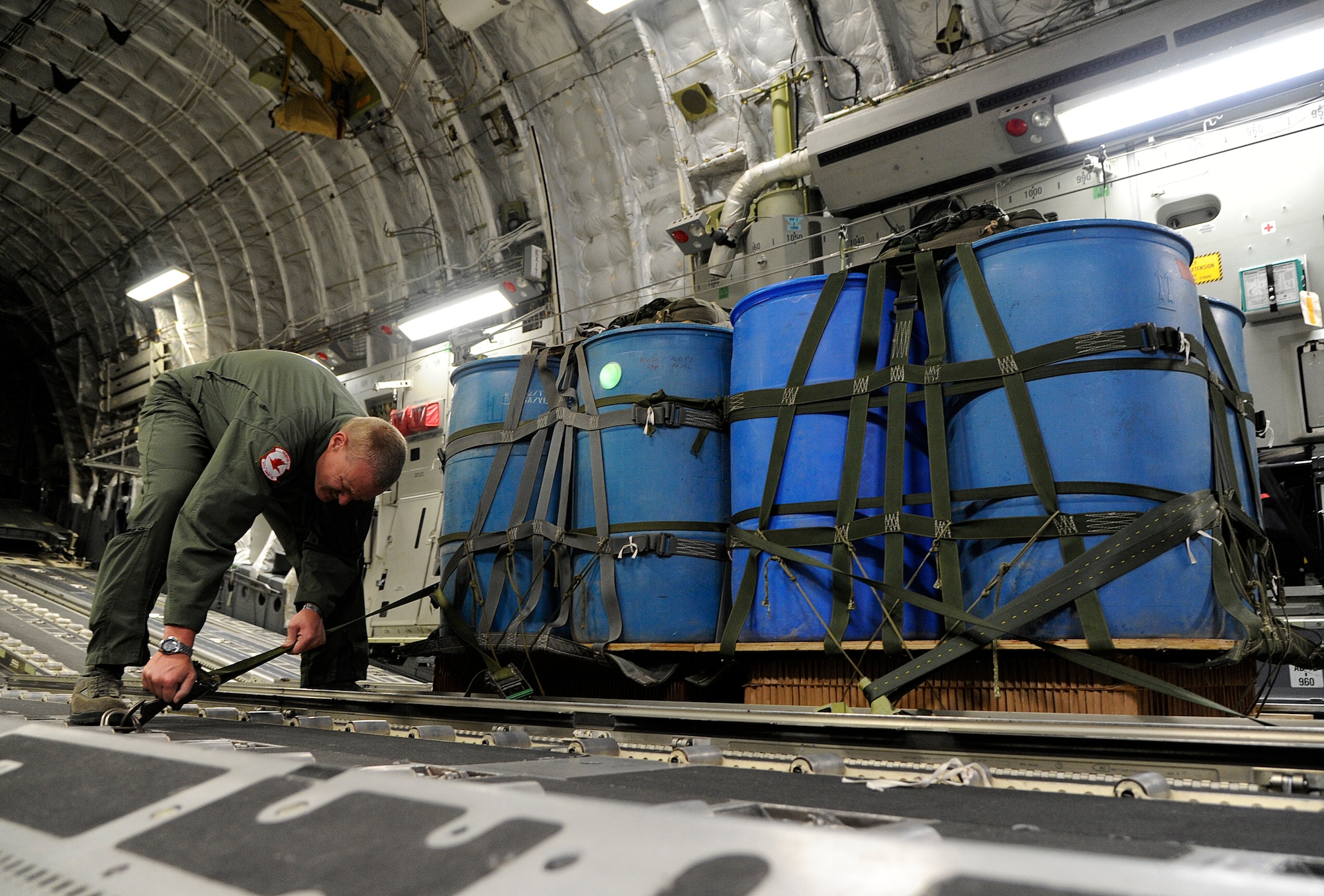 Tech. Sgt. Terry Langston, 517th Airlift Squadron loadmaster, straps down two pallets in preparation for a heavy drop from a C-17 Globemaster III cargo plane on Joint Base Elmendorf-Richardson, Aug. 23, 2012. C-17 aircraft from JBER support a variety of missions around the world, many of which include dropping U.S. Army paratroopers. (U.S. Air Force photo by Staff Sgt. Zachary Wolf)