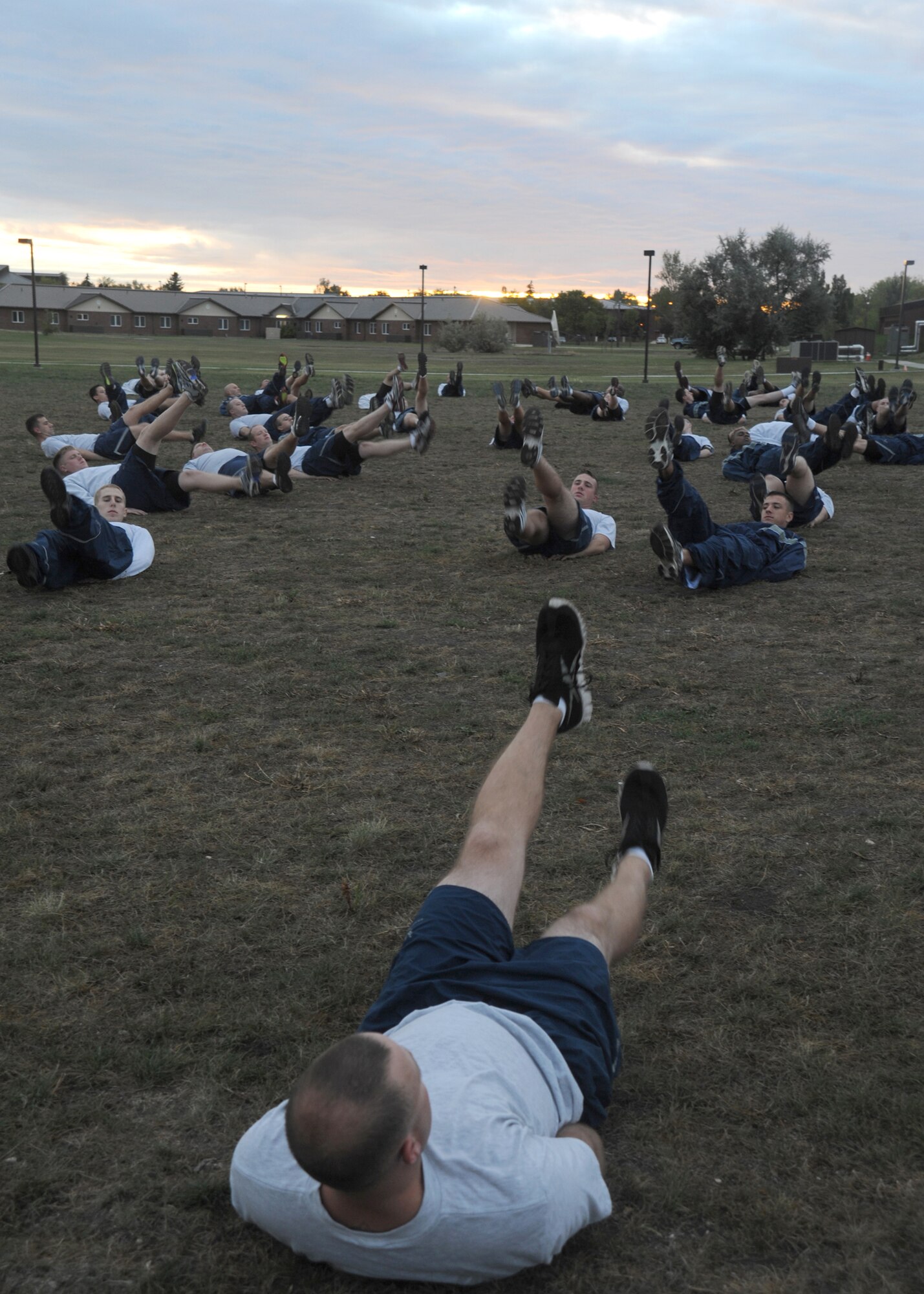 Members of 319th Logistics Readiness Squadron perform flutter kicks, Sept. 7, 2012, on Grand Forks Air Force Base, N.D. The 319th LRS performed three sets of flutter kicks as part of the 1 Million Kick Event challenge, as an initiative sponsored impart by the Presidents Active Lifestyle Award program with the goal of “kicking obesity out of America.” (U.S. Air Force photo/ Airman 1st Class Xavier Navarro)