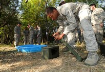 MINOT AIR FORCE BASE, N.D. – Airman 1st Class Quincy Brooks, 91st Missile Security Forces Squadron response force leader, secures a battery with a latch as part of an obstacle which required the movement of individuals and items across an area without touching the ground. During this Leadership Reaction Course, the lowest ranking Airmen were put in charge of NCO’s and Airmen and were the only ones allowed to speak and direct commands to accomplish the obstacles.  (U.S. Air Force photo/Senior Airman Jose L. Hernandez)
