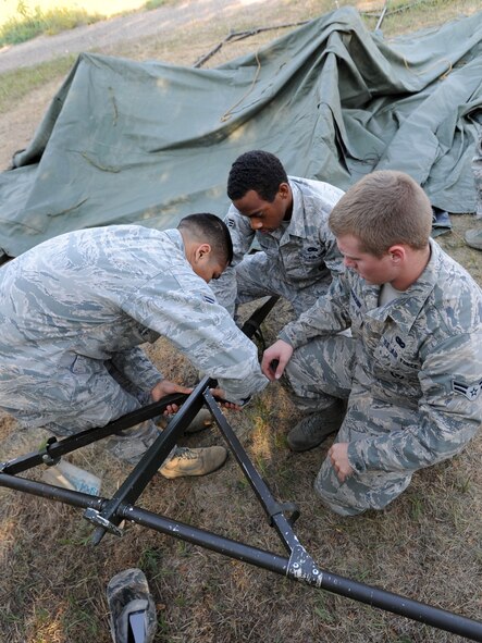 MINOT AIR FORCE BASE, N.D. – Airmen from the 91st Missile Security Forces Squadron work together to build a temper tent, during a Leadership Reaction Course, here August 29. Members of the squadron partook in a training course designed to teach leadership skills to lower-ranking Airmen by placing them in charge of obstacles and challenging tasks. (U.S. Air Force photo/Senior Airman Jose L. Hernandez)