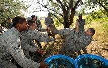 MINOT AIR FORCE BASE, N.D. – Airmen from the 91st Missile Security Forces Squadron work together to move themselves across an obstacle to another during a Leadership Reaction Course, here August 29. Members of the squadron partook in a training course designed to teach leadership skills to lower-ranking Airmen by placing them in charge of obstacles and challenging tasks. During this task, only the lowest ranking Airman was allowed to speak and direct commands to accomplish the obstacle. The tasks were designed to be both fun and challenging. (U.S. Air Force photo/Senior Airman Jose L. Hernandez)
