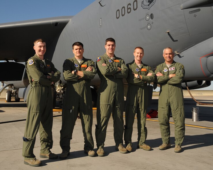 MINOT AIR FORCE BASE, N.D. -- Crew members from the 23rd Bomb Squadron, and Col. Robert Vercher, 91st Missile Wing commander, pose next to a buff here Sept. 5. Vercher took part in first flight on a B-52H Stratofortress that day and had an opportunity to witness procedures required for an in-flight refueling mission. (U.S. Air Force Photo/Airman 1st Class Andrew Crawford)