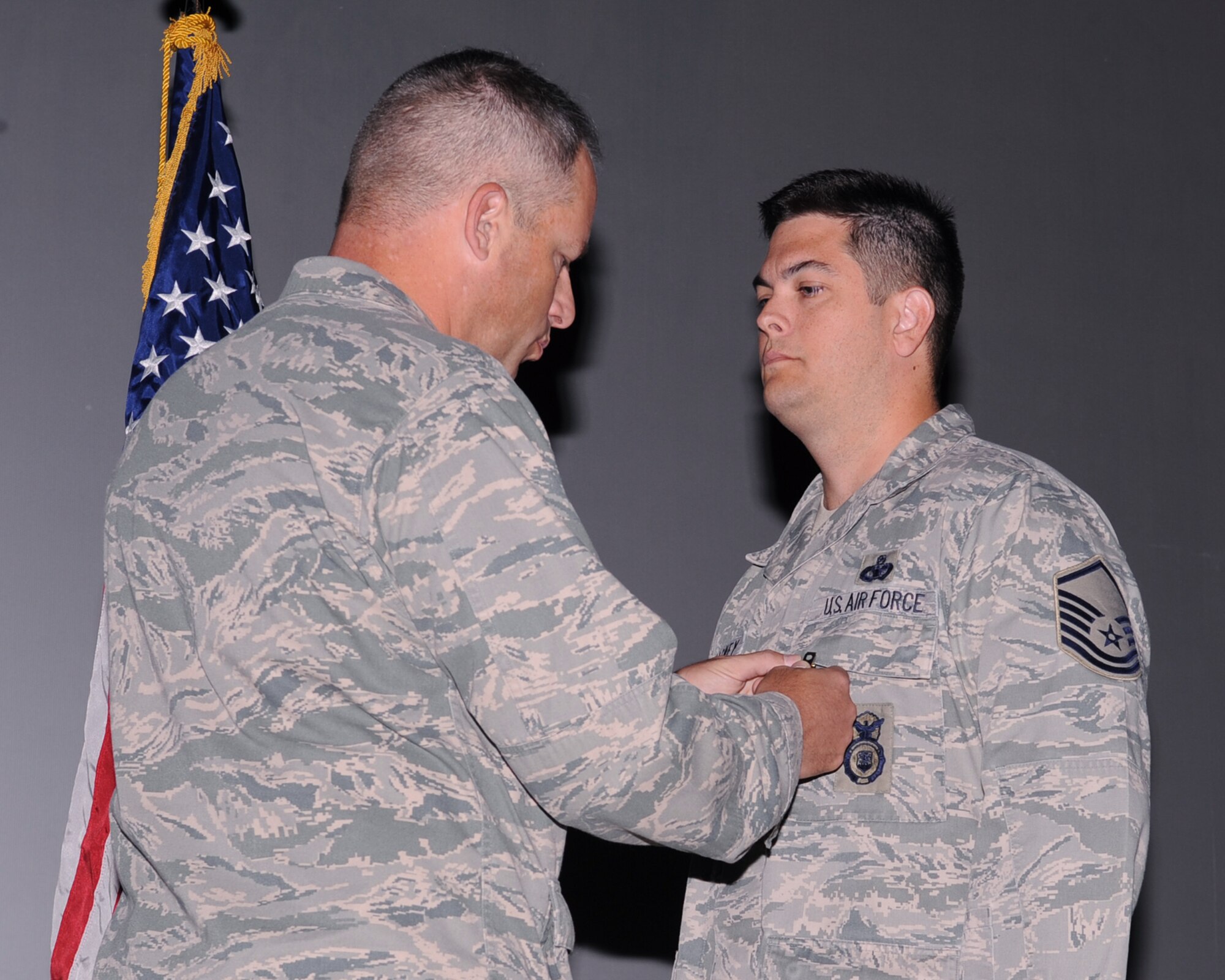 U.S. Air Force Col. Greg Williams, 355th Mission Support Group commander, pins Master Sgt. Brian LaMasney, 355th Security Force Squadron, with the Bronze Star medal on Davis-Monthan Air Force Base, Ariz., Sept. 6, 2012. Sergeant LaMasney received the star for his meritorious service while deployed overseas. (U.S. Air Force photo by Airman 1st Class Christine Griffiths/Released) 