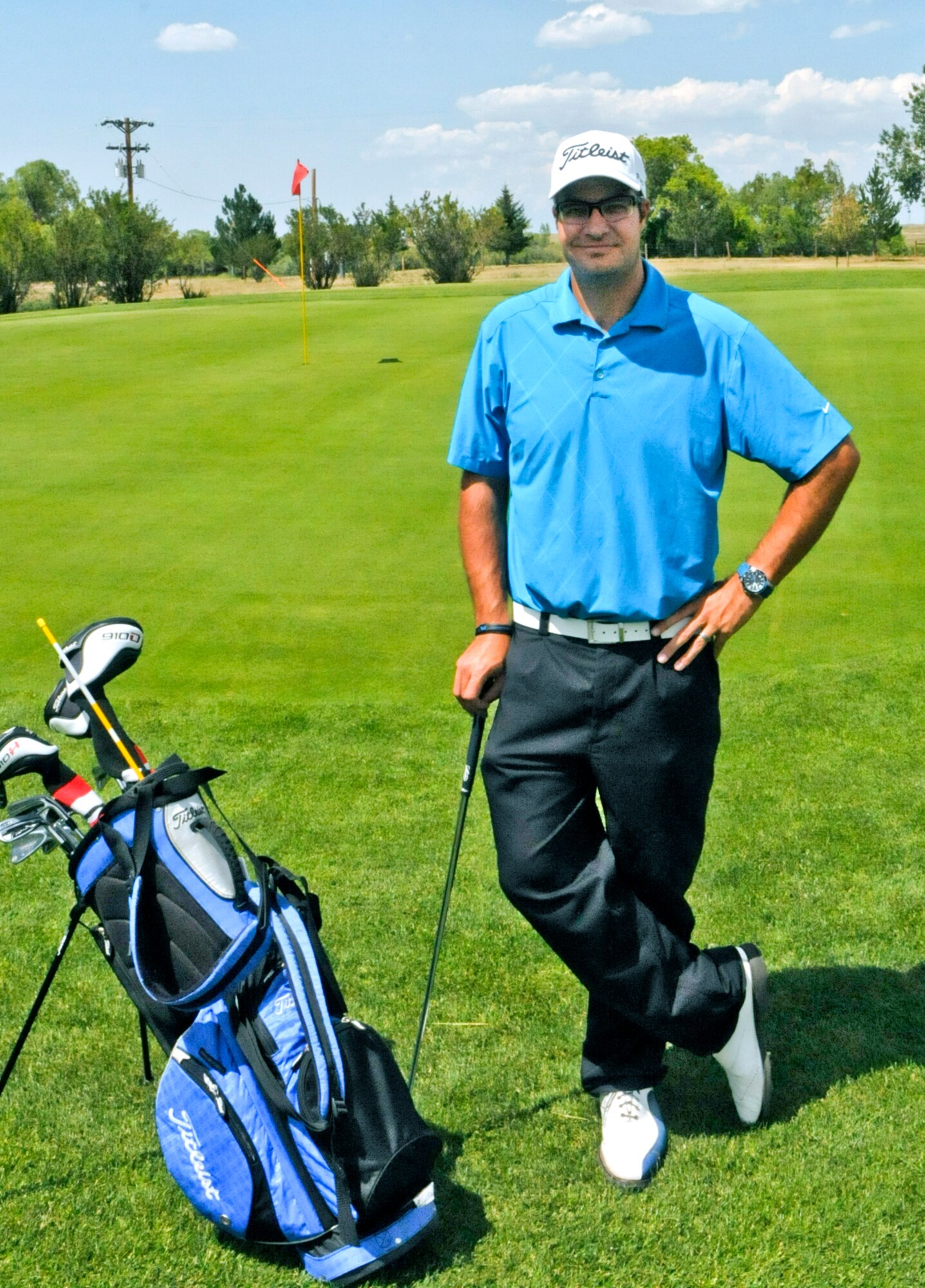 First Lt. Tom Whitney, 319th Missile Squadron deputy missile combat crew commander, poses with his clubs on the F. E. Warren Air Force Base Golf Course Aug. 7. (U.S. Air Force photo by Airman 1st Class Jason Wiese)