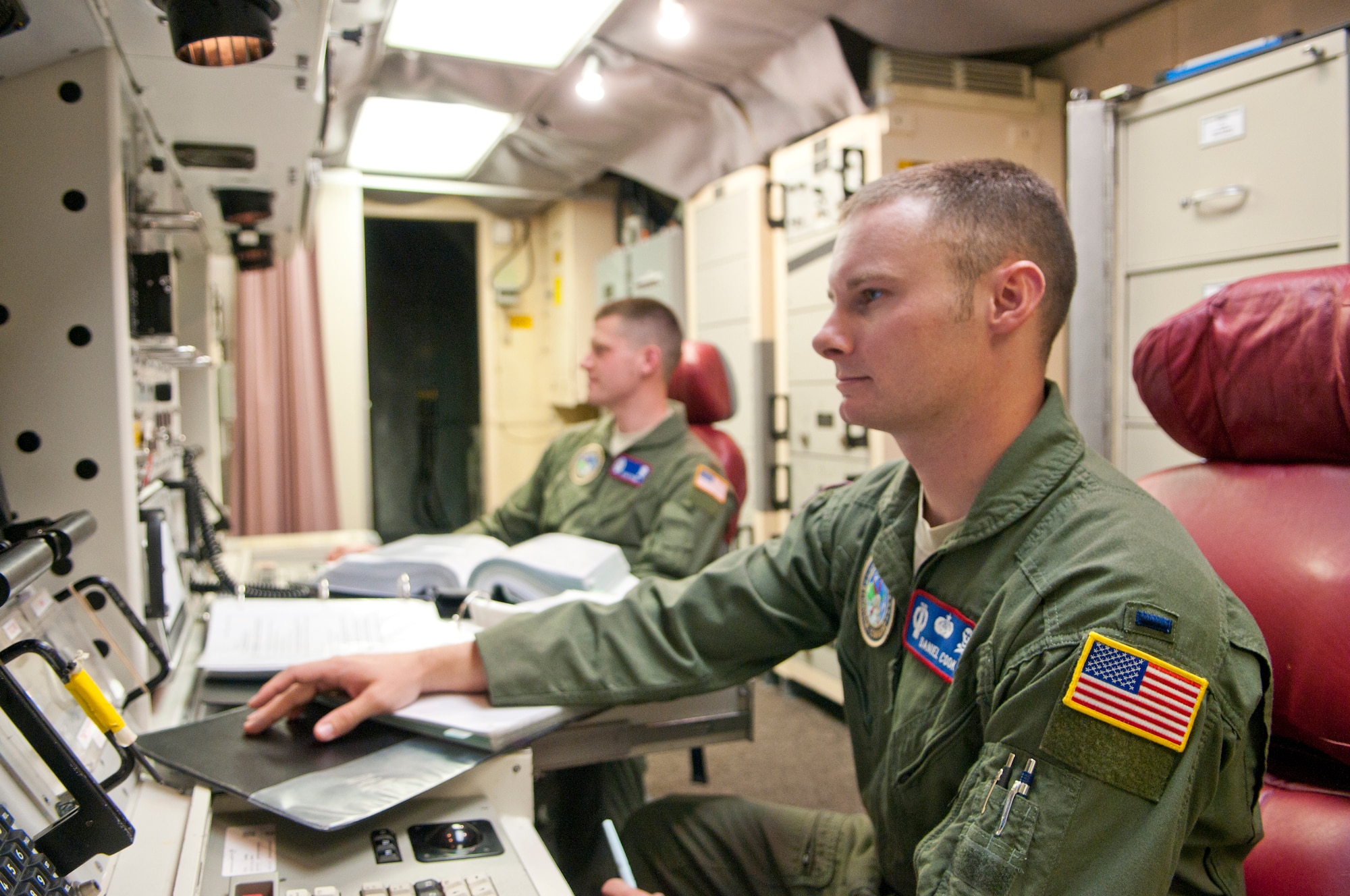 First Lt. Daniel Cook, 319th Missile Squadron missile combat crew commander, and 2nd Lt. Kyle Todd, 319th Missile Squadron deputy missile combat crew commander, man the launch control center of the Delta-01 missile alert facility Aug. 23. (U.S. Air Force photo by Airman 1st Class Jason Wiese)