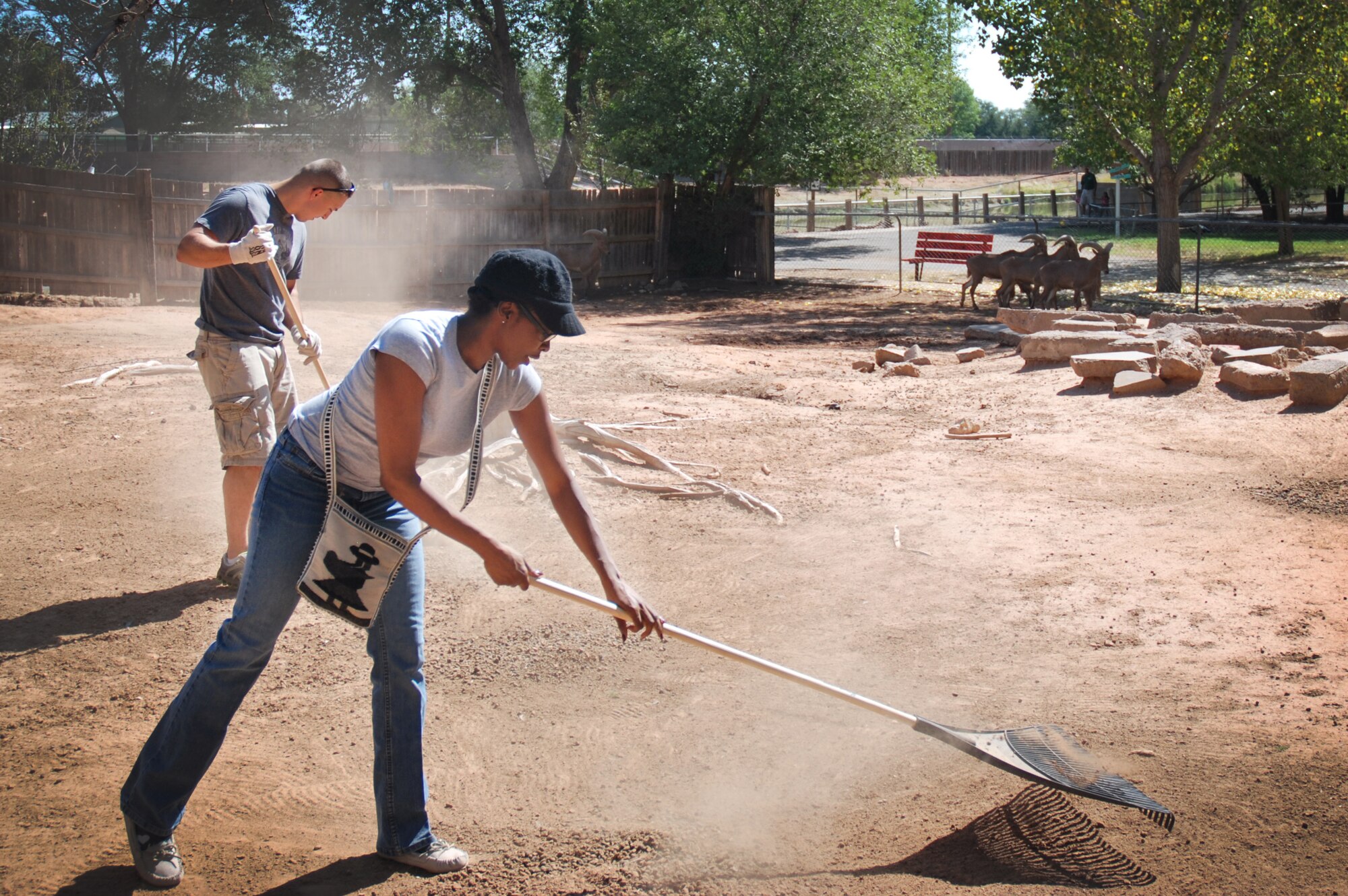 Two volunteers from Cannon Air Force Base, N.M., landscape the inside of an exhibit at The Hillcrest Zoo, Clovis, N.M., Aug. 31, 2012. Cannon's 5/6ers organized and coordinated the volunteer beautification project between base personnel and the zoo.  (Courtesy photo)  