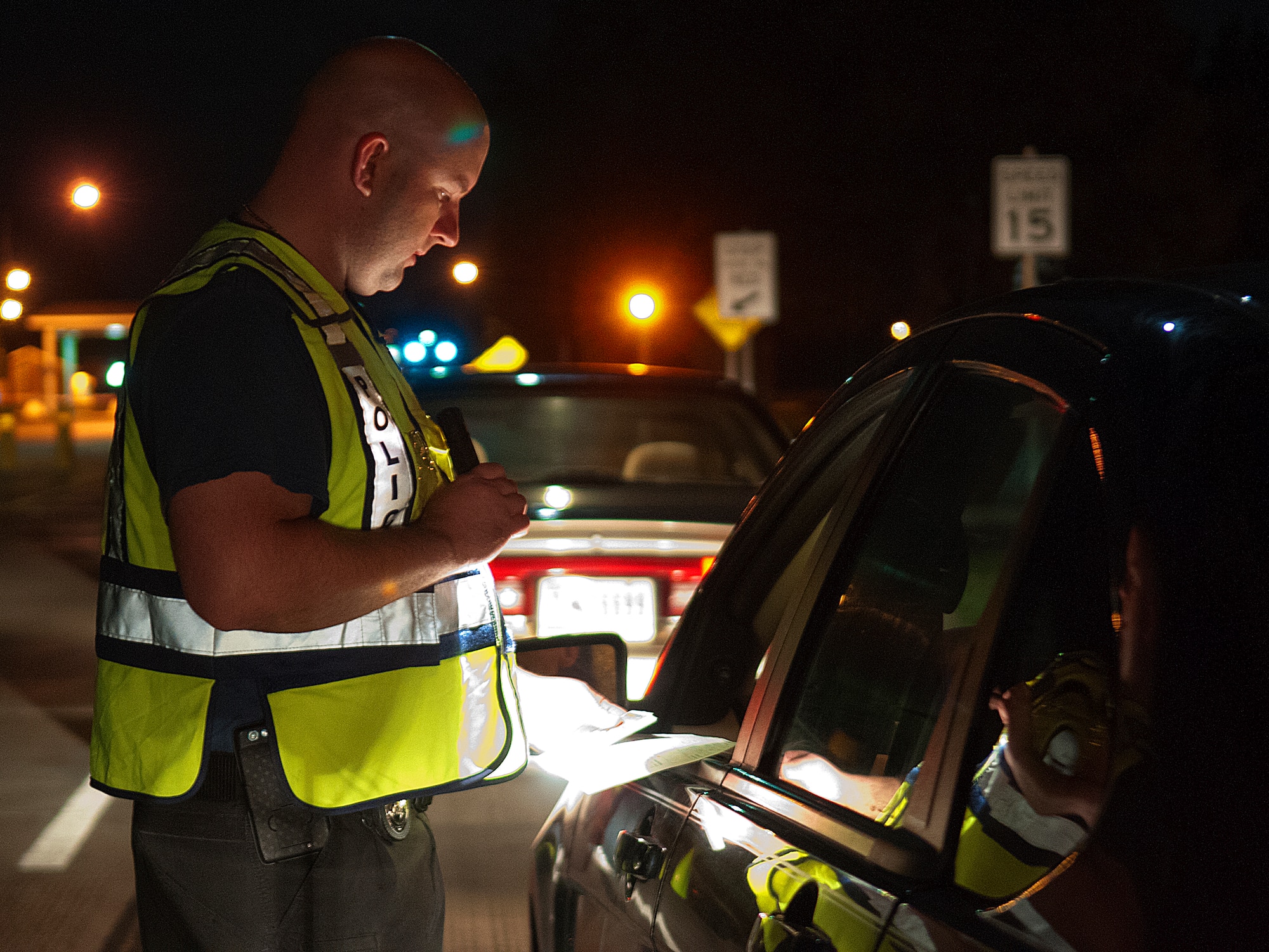 Tech. Sgt. Bob Powell, 90th Security Forces Squadron, checks the registration and insurance of a driver during a seatbelt enforcement stop on F.E. Warren Air Force Base, Wyo., August 31, 2012. Members of the 90 SFS stopped all vehicles leaving the base at the start of Labor Day weekend checking for the proper use of seatbelts and for cell phone use. (U.S. Air Force photo by R.J. Oriez)