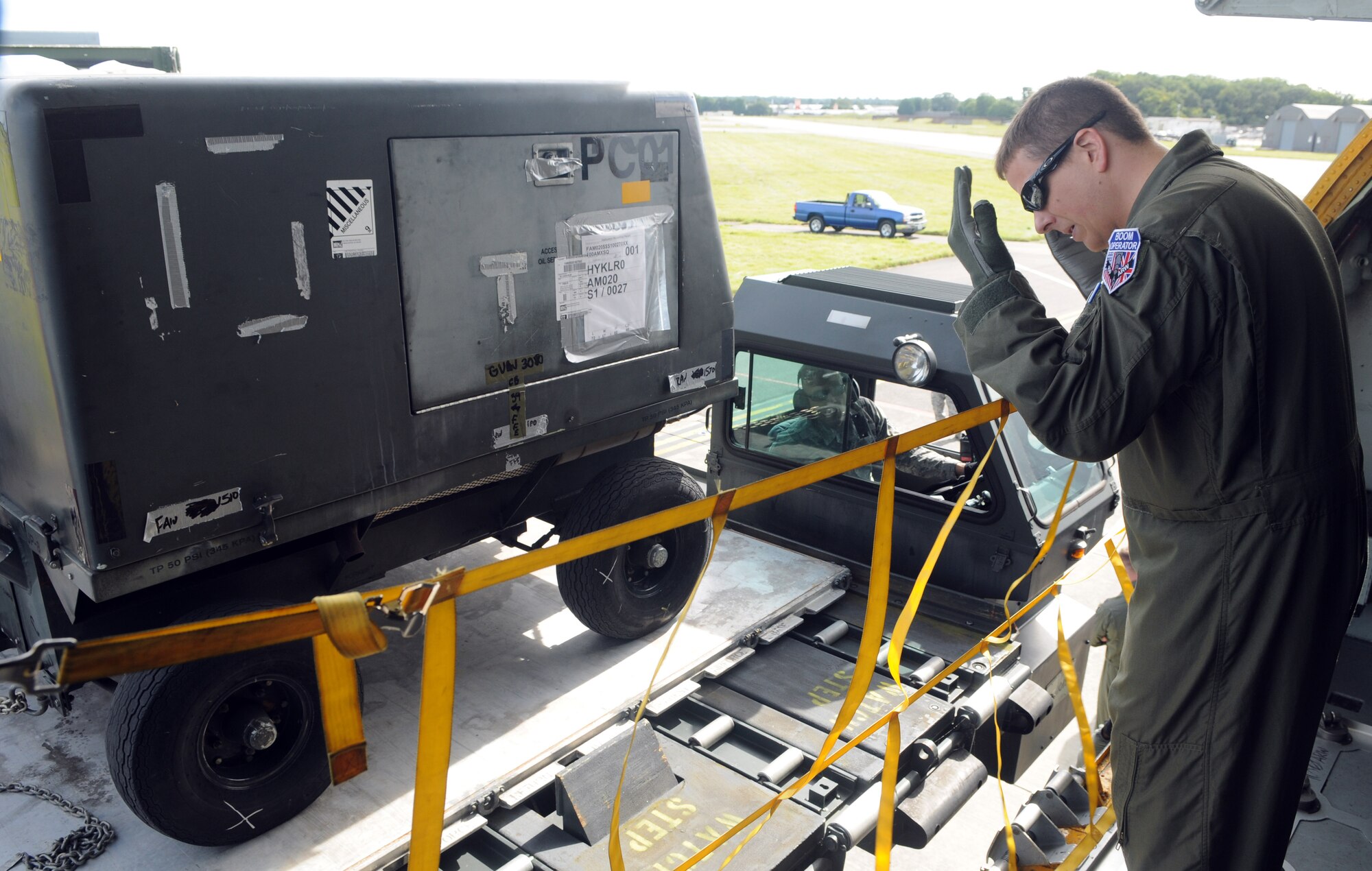 RAF MILDENHALL, England – Staff Sgt. Thomas Vesser, 351st Air Refueling Squadron, guides K-loader driver Tech. Sgt. Robert Hernandez, 727th Air Mobility Squadron, as he maneuvers the vehicle loaded with palletized cargo toward a KC-135 Stratotanker during phase one of an operational readiness exercise Sept. 6, 2012. The exercise is designed to test RAF Mildenhall’s ability to rapidly deploy in support of global operations. (U.S. Air Force photo/Staff Sgt. Austin M. May)
