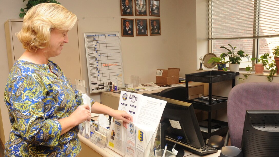 Karen Hazle – Johnson, 28th Force Support Squadron Airman and Family Readiness director, places brochures for the different programs available to Airmen and their families at the Airman and Family Readiness Center at Ellsworth Air Force Base, S.D., Sept. 5, 2012. The A&FRC offers several programs, ranging from the intricacies of mission deployment readiness to relationships, for all Air Force members and their families. For more information on the many available programs, call the Airman and Family Readiness Center at (605) 385-4663. (U.S. Air Force photo by Airman 1st Class Anania Tekurio/Released)