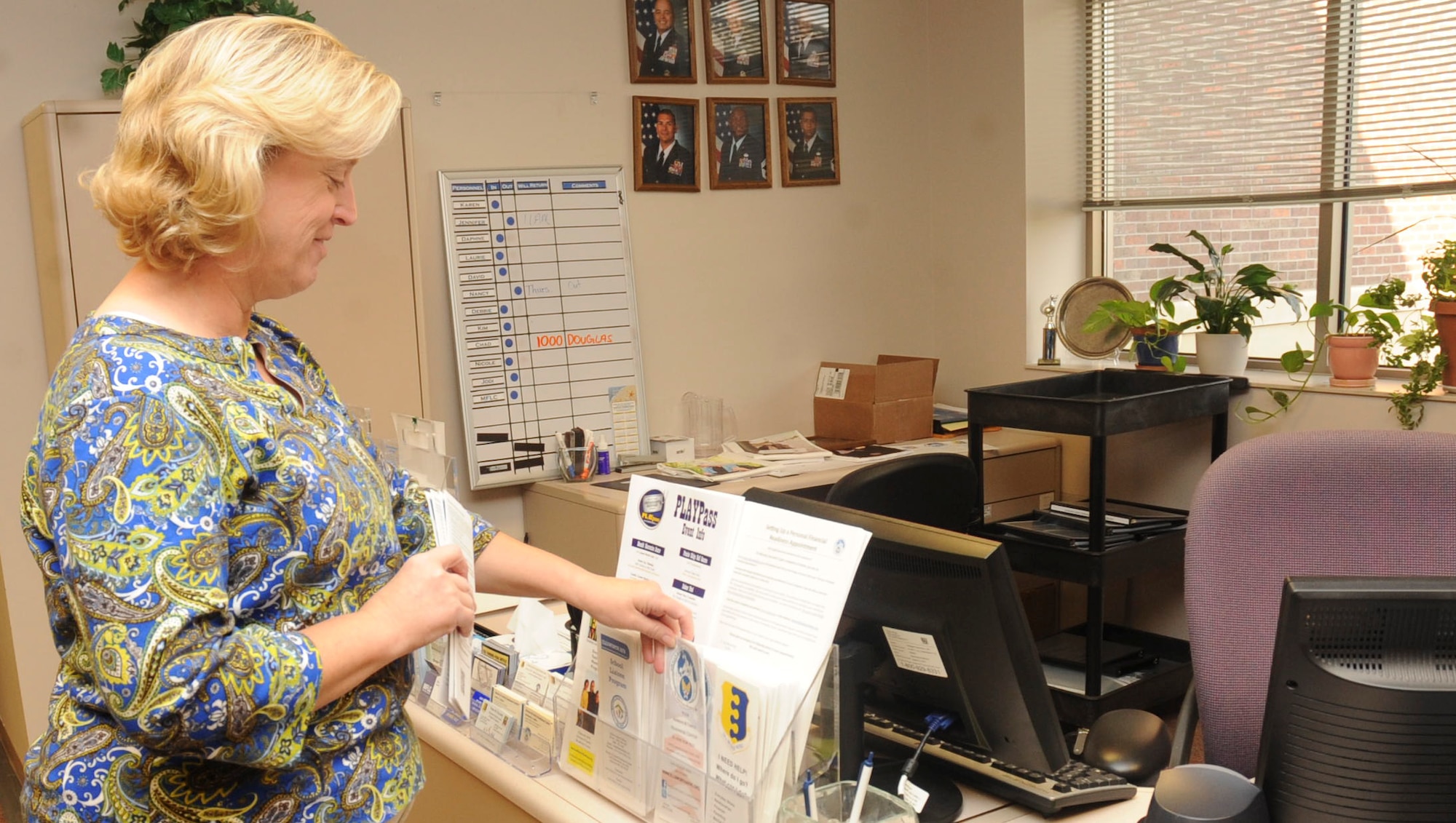 Karen Hazle – Johnson, 28th Force Support Squadron Airman and Family Readiness director, places brochures for the different programs available to Airmen and their families at the Airman and Family Readiness Center at Ellsworth Air Force Base, S.D., Sept. 5, 2012. The A&FRC offers several programs, ranging from the intricacies of mission deployment readiness to relationships, for all Air Force members and their families. For more information on the many available programs, call the Airman and Family Readiness Center at (605) 385-4663. (U.S. Air Force photo by Airman 1st Class Anania Tekurio/Released)
