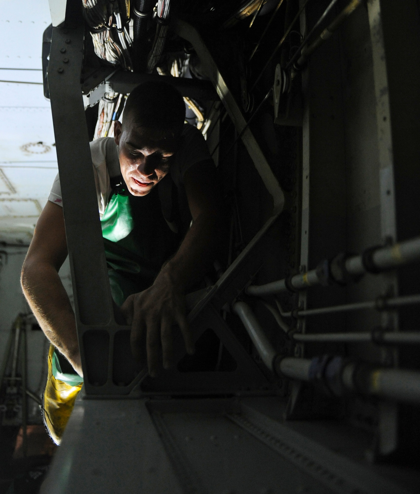 An Airman from the 2nd Maintenance Squadron scrubs the crawl space inside the bomb-bay of a B-52H Stratofortress on Barksdale Air Force Base, La., Aug. 22. B-52s are brought into the corrosion hangar after 450 flying hours to be cleaned. Along with the exterior, the aircraft?s bomb-bay, landing gears and entryway are scrubbed clean. (U.S. Air Force photo/Airman 1st Class Micaiah Anthony)(RELEASED)