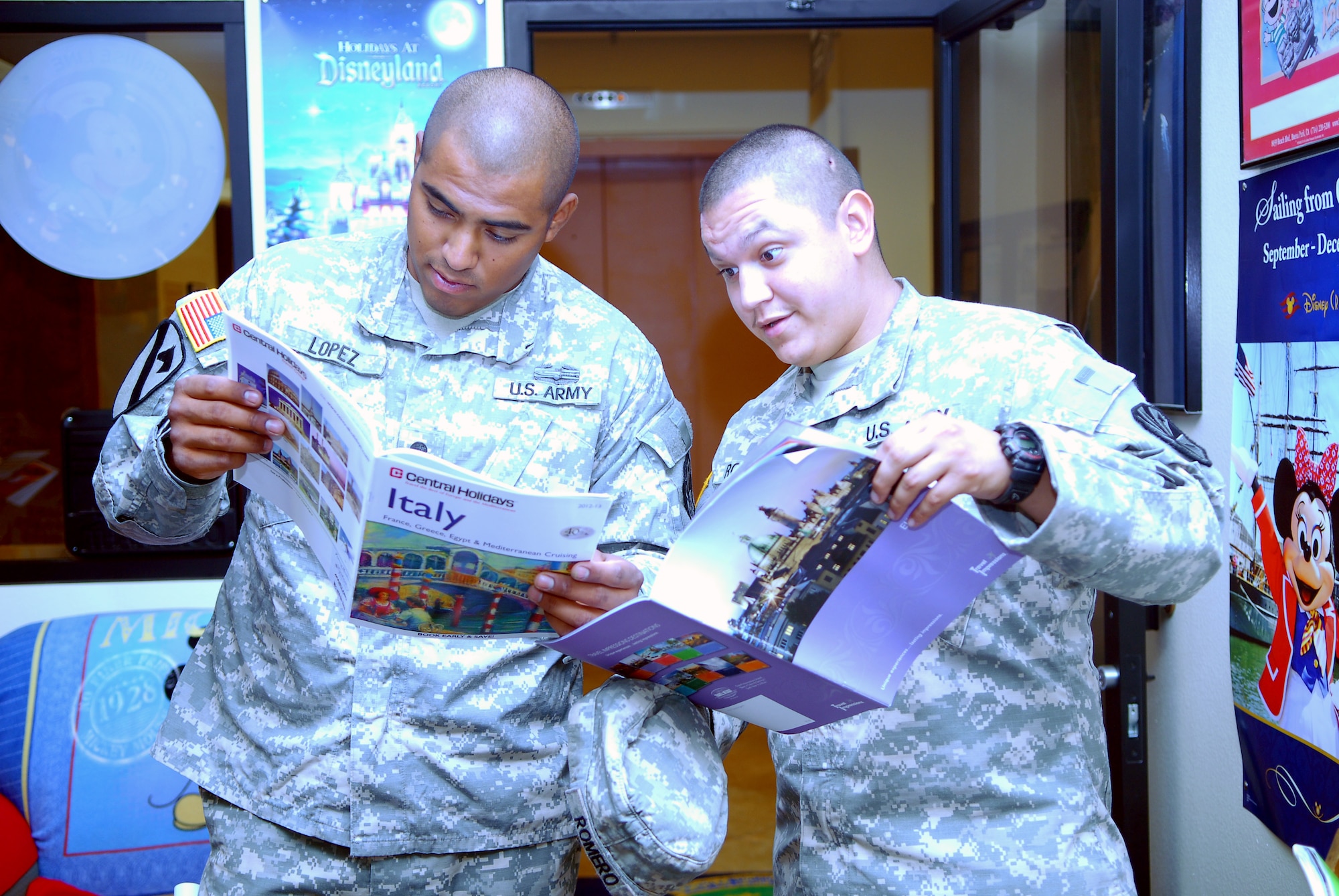 Army Spc. Christian Lopez, 258th Engineer Company engineer, left, and Pvt. Andrew Romero, 258th EC engineer, check out brochures at the Information, Tickets and Travel office on Luke Air Force Base Aug. 29. ITT is located in Bldg. 1150 and offers deals on tickets, airfares and more to military personnel, family members and Defense Department employees.  (U.S. Air Force photo by Airman 1st Class Grace Lee)