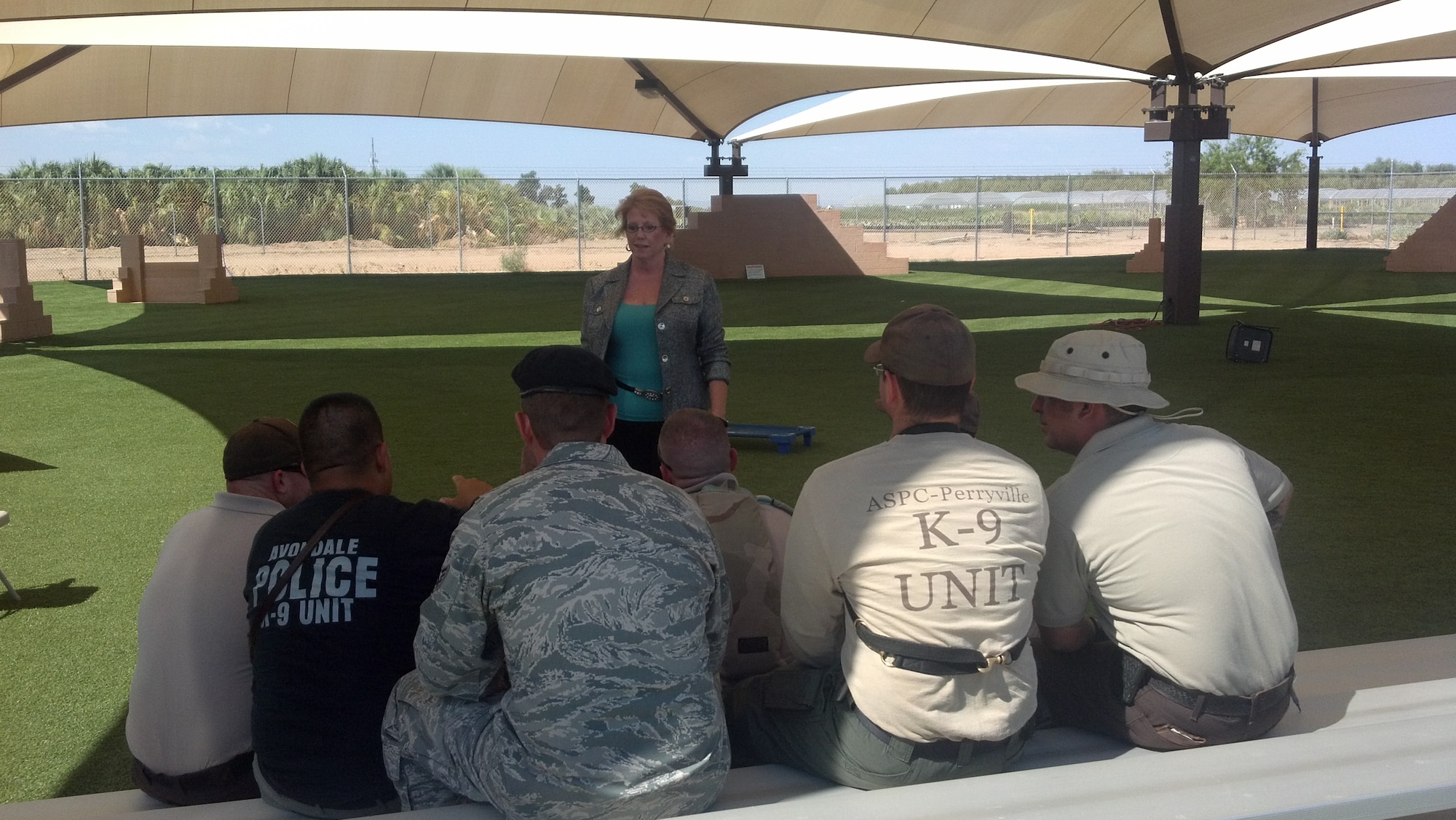 Susan Simons, Under the Shield president, speaks to personnel from the 56th Security Forces Squadron along with members of local law enforcement agencies Aug. 29 at the military working dog kennels on Luke Air Force Base. Simons works with the 56th SFS and local police Wednesdays teaching them how to be mentally prepared for stressful situations. (Courtesy photo)