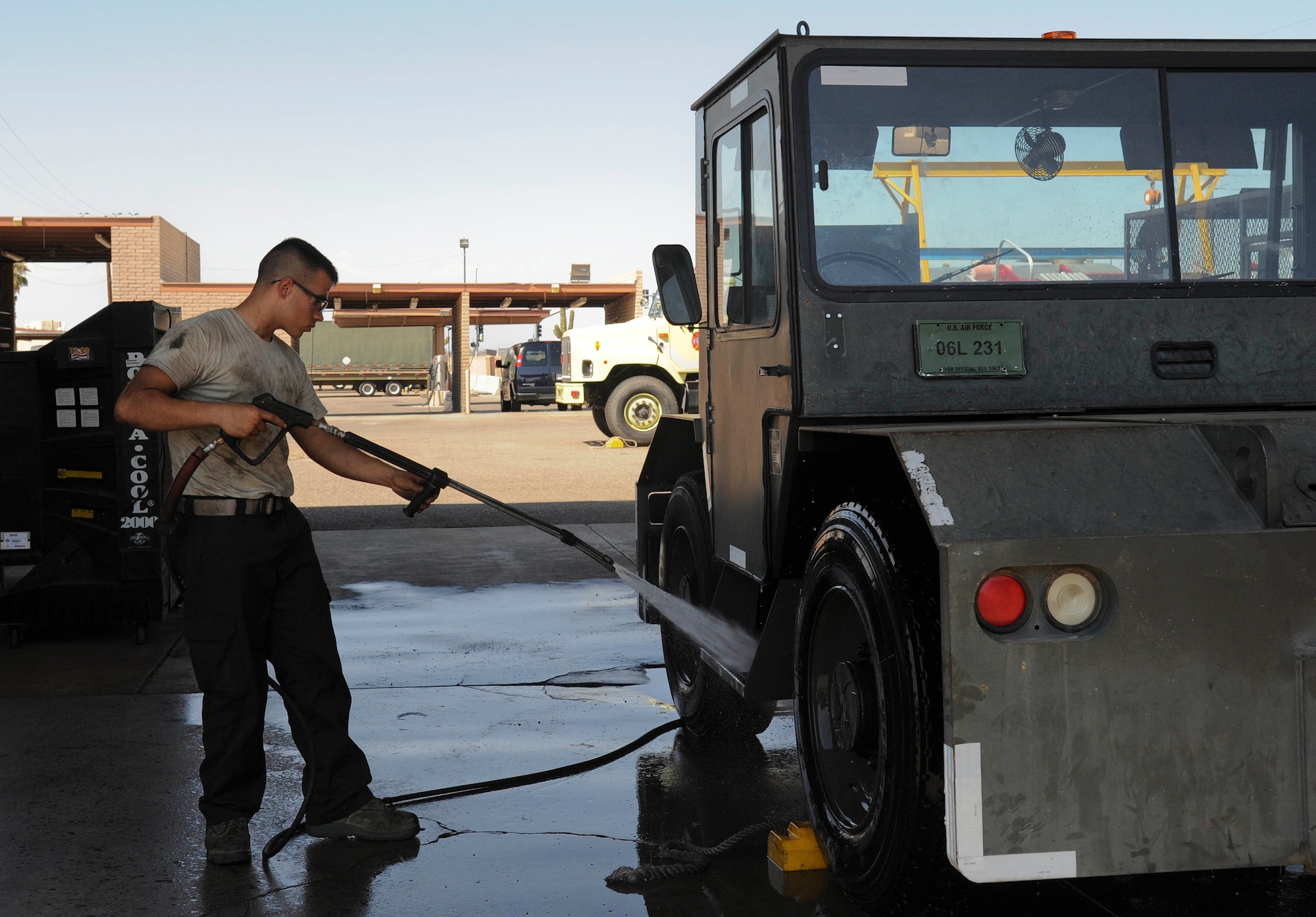 Airman 1st Class Logan Wygal, 56th Logistics Readiness Squadron vehicle mechanic, washes a MB-4 tow tractor at the wash rack. (U.S. Air Force photo by Staff Sgt. Darlene Seltmann)