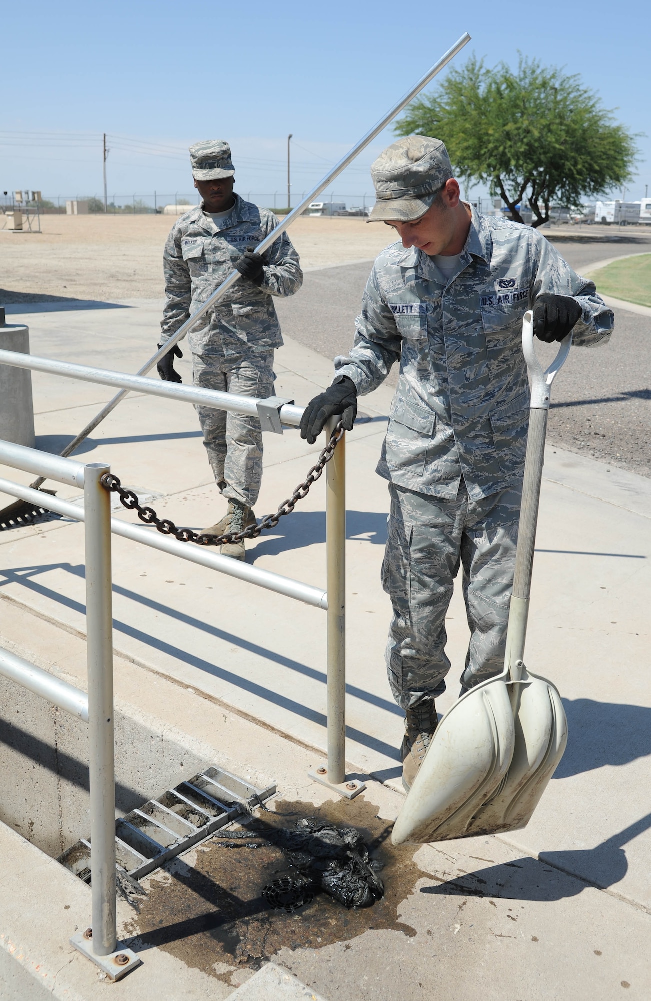 Senior Airman Josh Billett, 56th Civil Engineer Squadron water and fuels system maintenance technician, presses waste water from the gunk collected from the bar screen at the waste water plant. Of the 500,000 to 600,000 gallons of waste and sewage that goes into the plant daily, the plant puts out between 300,000 and 350,000 gallons of recycled water used for irrigation. (U.S. Air Force photo by Staff Sgt. Darlene Seltmann)