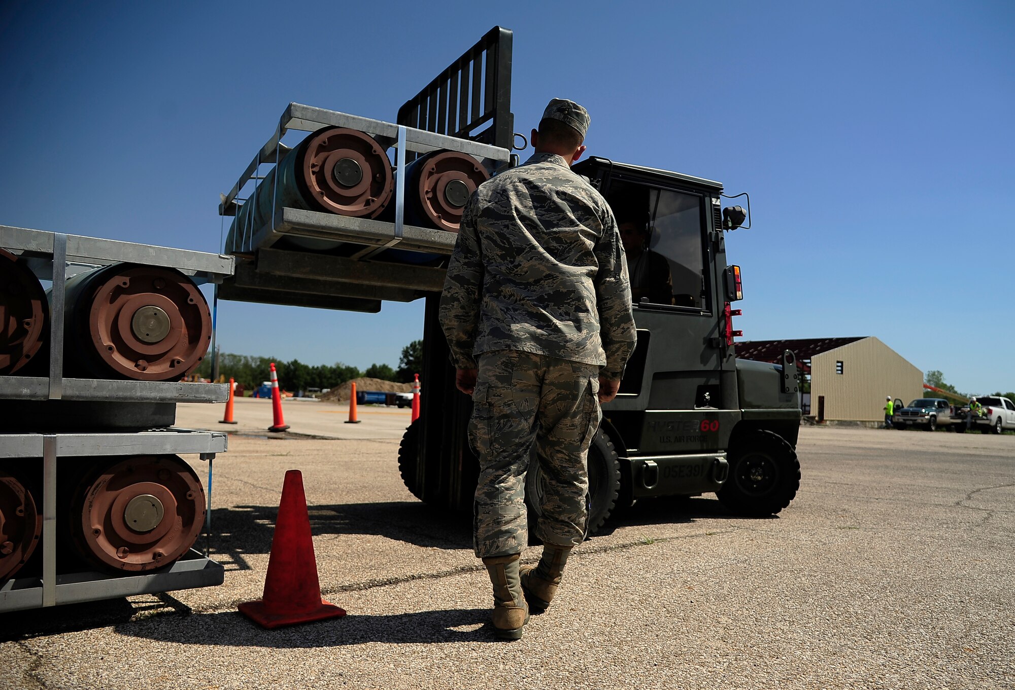 Airman 1st Class Joe Villines, 509th Munitions Squadron, restacks munitions pallets quickly and effectively with the help of his guider during the Air Force Global Strike Command Challenge at Whiteman Air Force Base, Mo., Sept. 5. The challenge is an annual opportunity for units under AFGSC to push themselves and each other in friendly competition. (U.S. Air Force photo/ Senior Airman Cody H. Ramirez)