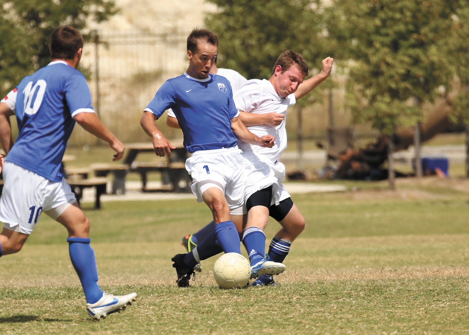 Sam Page (middle) of Joint Base San Antonio-Randolph soccer team competes against the Columbus Air Force Base soccer team during the Defender Cup tournament, Sept. 2. (U.S. Air Force photo/Robbin Cresswell)