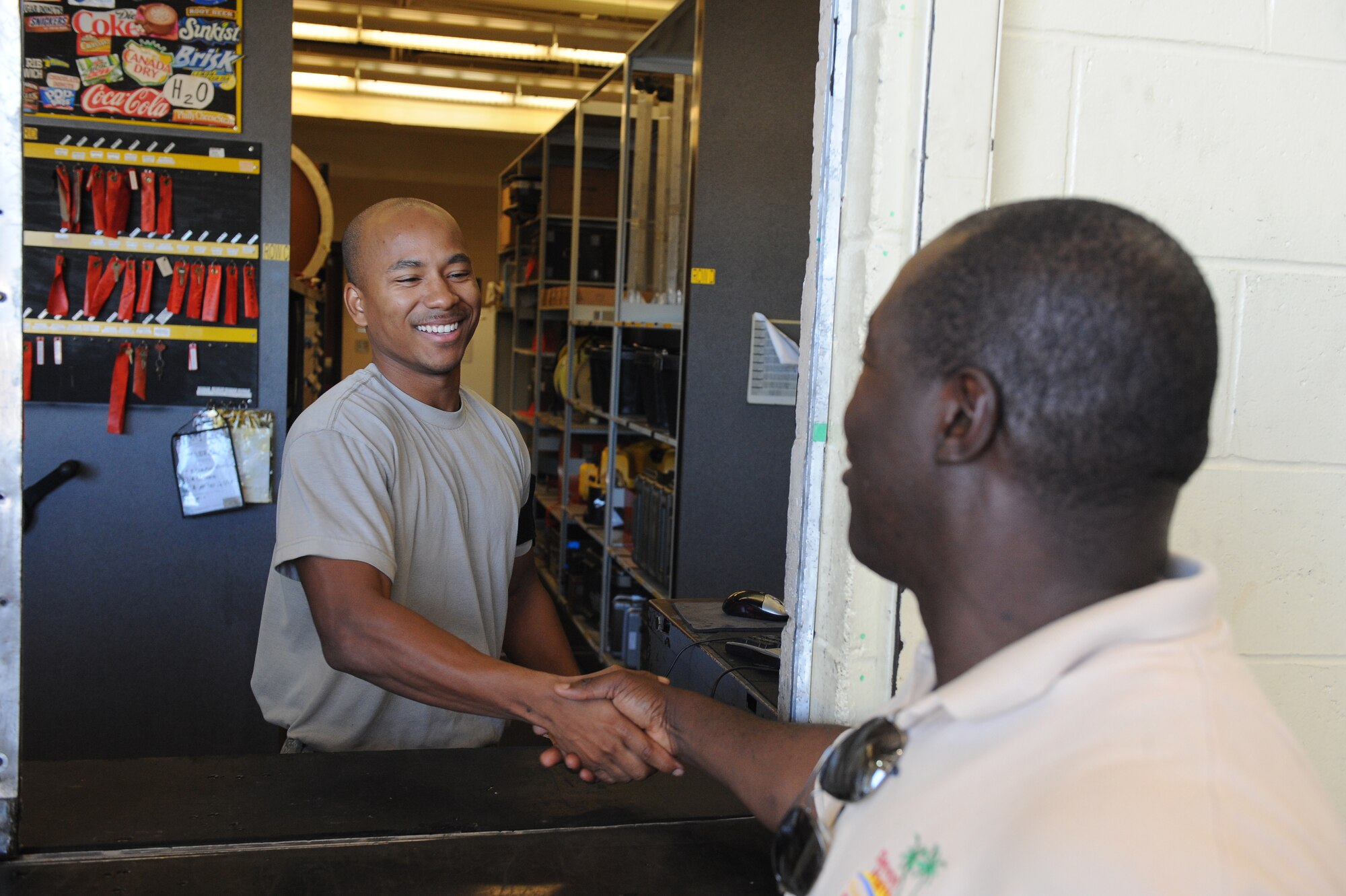 Retired Jamaican Army Capt. Devon Harris, three-time Olympic Jamaican Bobsledder, shakes hands with a Barksdale Airman in the Phase Hangar on Barksdale Air Force Base, La., Sept. 5. Harris toured the base as a part of the American 300 Tour to motivate Airmen by telling his story. Harris went from living in poverty to becoming one of the first Olympic Jamaican Bobsledders. (U.S. Air Force photo/Airman 1st Class Micaiah Anthony)(RELEASED)