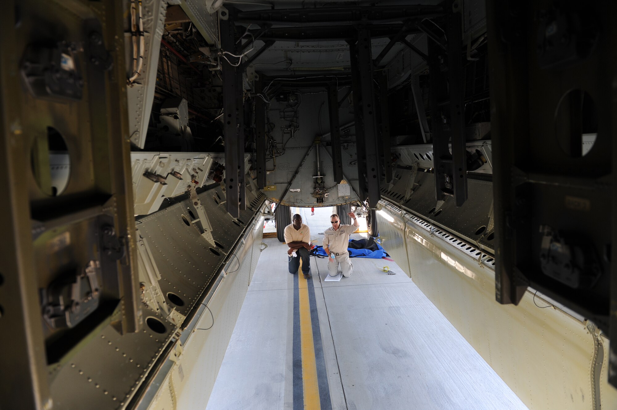 Retired Jamaican Army Capt. Devon Harris, three-time Olympic Jamaican Bobsledder, and Robi Powers, American 300 founder, look at the bomb-bay of a B-52H Stratofortress on Barksdale Air Force Base La., Sept. 5. Harris and Powers toured the flightline with a Barksdale chaplain to raise morale and handed out popsicles and sports drinks to Airmen. Harris was one of the first Jamaican Bobsledders in Olympic history.(U.S. Air Force photo/Airman 1st Class Micaiah Anthony)(RELEASED)
