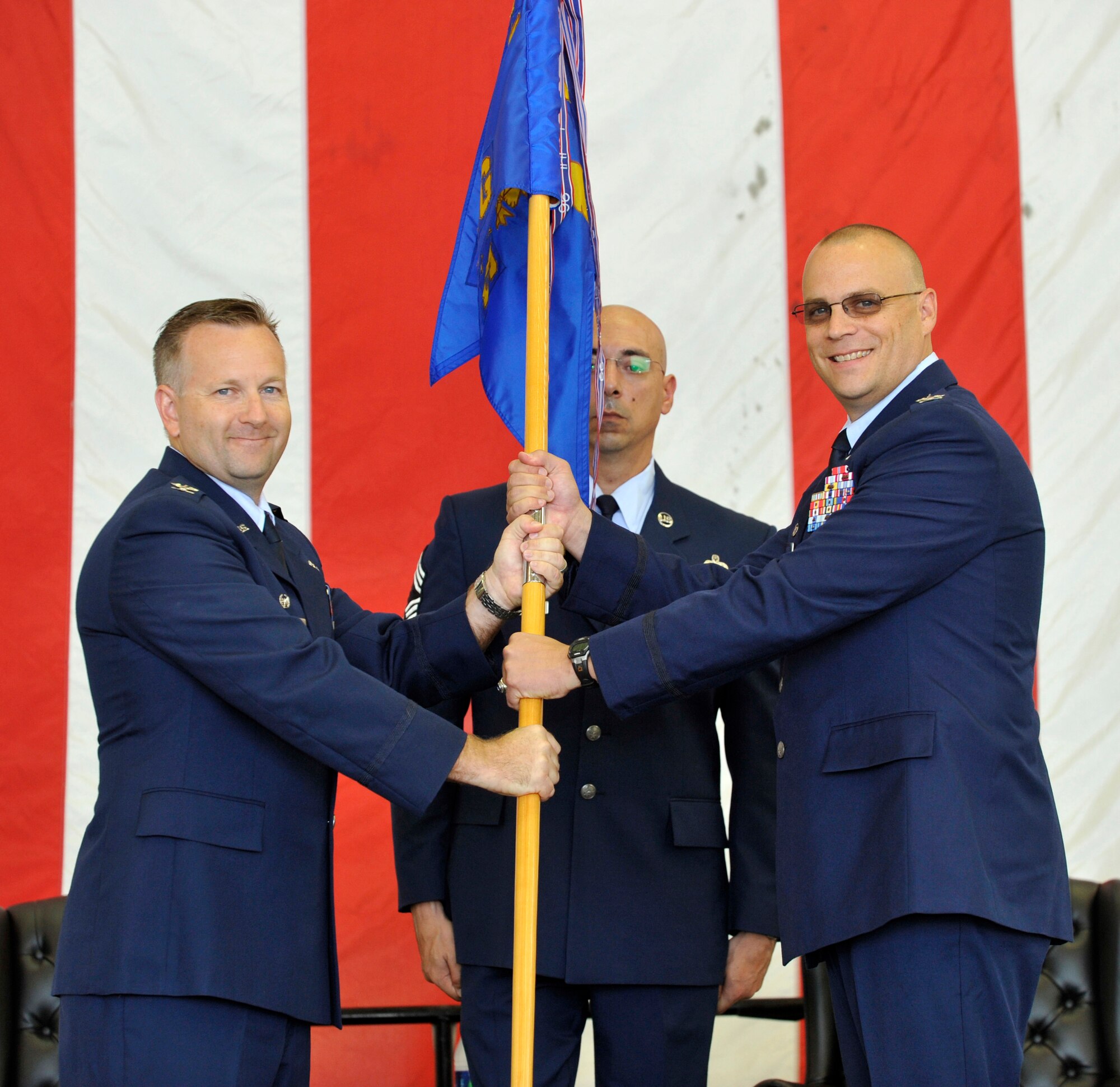 Col. Richard Williamson, 305th Air Mobility Wing commander, hands Col. John
Mateer the guidon and command of the 305th Maintenance Group during the
Assumption of Command Ceremony in Dock 1 Aug. 31 on McGuire Airfield. (U.S.
Air Force photo by Wayne Russell/Released)