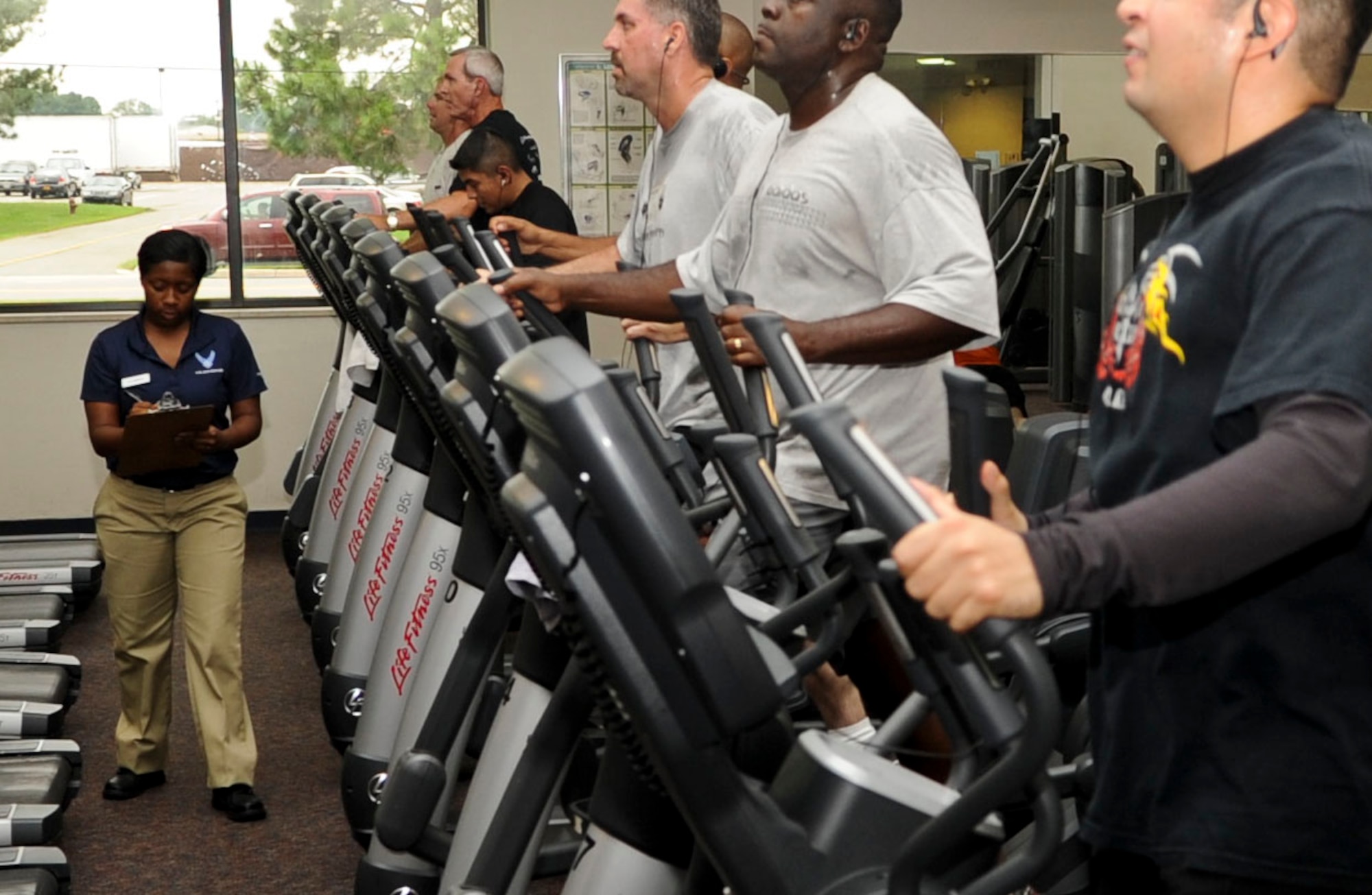 Airman 1st Class Shanique Cameron, 633rd Force Support Squadron fitness specialist, writes down the number of people currently using cardio equipment on her checklist inside the Shellbank Fitness Center at Langley Air Force Base, Va., Sept. 6, 2012. The checklist is completed several times a day by fitness center staff to track the overall usage of the facility. (U.S. Air Force photo by Staff Sgt. Wesley Farnsworth / Released)