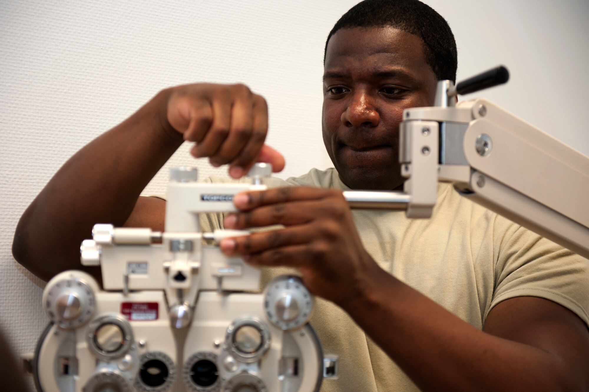 SPANGDAHLEM AIR BASE, Germany – Tech. Sgt. Douglas Cox, 52nd Medical Support Squadron biomedical equipment repair technician, assembles an optometry chair in the new 52nd Medical Group clinic here Sept. 5.  The 52nd Medical Group has spent the last few weeks moving all sections of the previous building, into the new one.  The $30.1 million clinic officially opens Sept. 10 and includes a larger parking lot, a 75,000 square foot building, 23 exam rooms, 218 medical professionals, and new medical equipment and furniture.  (U.S. Air Force photo by Airmen 1st Class Gustavo Castillo/Released)