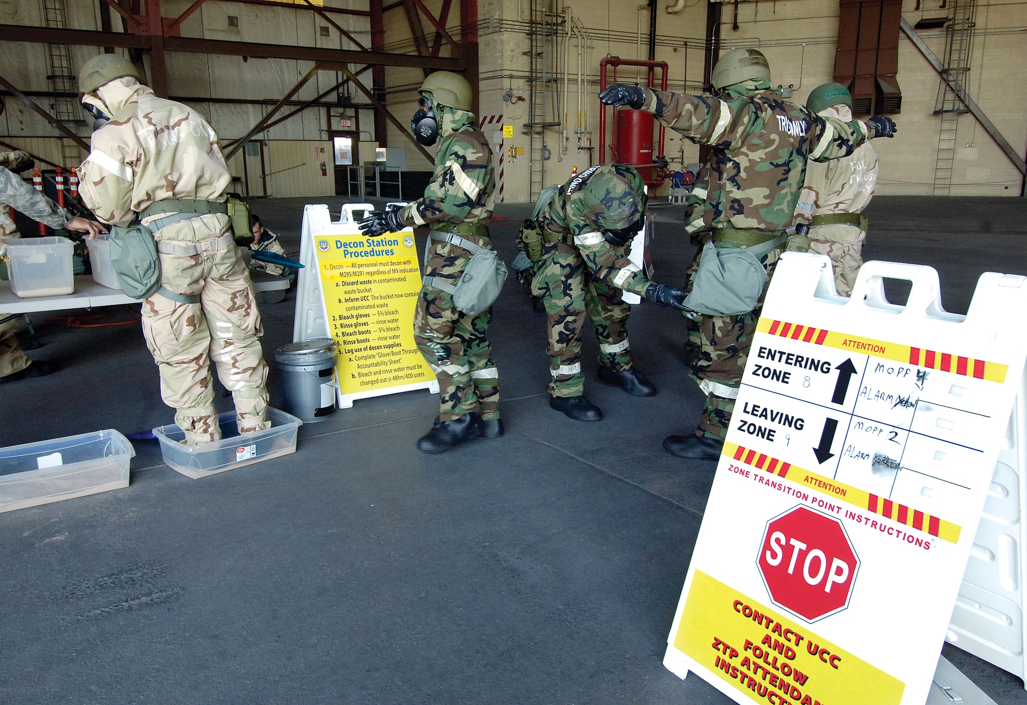 A mock decontamination area taught Airmen how to move from a contaminated zone to a clean zone by moving through decontamination baths. (Air Force photo by Margo Wright)