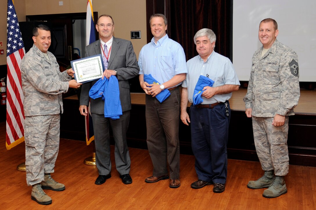 RAF MENWITH HILL, United Kingdom - Col. Brian Kelly, 501st Combat Support Wing commander, presents an Innovator of the Month certificate to the 421st Civil Engineer Squadron programs flight during a commander’s call at RAF Menwith Hill Sept. 6, 2012. (U.S. Air Force photo by Staff Sgt. Debbie Lockhart) 