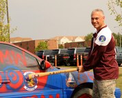 MINOT AIR FORCE BASE, N.D. -- Col. Robert J. Vercher, 91st Missile Wing commander, poses next to a vehicle that is ready to be smashed as part of the festivities held by the wing signifying the start of the Global Strike Challenge. Airmen from the wing held a kick-off ceremony Aug. 31 and as part of the event, had the opportunity to take a slammin' to two vehicles. (U.S. Air Force photo/Airman 1st Class Andrew Crawford)
